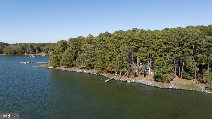 Welcome to "Point of View" – Your Waterfront Sanctuary in St. Michaels, MD! Discover the perfect blend of elegance and tranquility in this stunning coastal-style home nestled on 4+/- acres with 220 feet of riprapped shoreline along picturesque Broad Creek. Boasting breathtaking southwesterly views and designed to capture the essence of serene waterfront living, this property is a rare gem in a highly sought-after location. The 3-4BR/3.5BA home offers a contemporary yet timeless design with hardwood and slate flooring, architectural ceilings, and an abundance of natural light throughout. The main level showcases expansive water views from nearly every room, including a spacious first-floor primary suite with its perfect balance of privacy and convenience. The open living area features a soaring cathedral ceiling and woodburning fireplace, creating a welcoming ambiance for year-round enjoyment. The heart of the home, a newly remodeled kitchen, features an island, Maple cabinetry, stainless steel appliances, and a sunroom that can double as a dining area or additional living space. This sunlit retreat opens to an expansive waterside slate patio, ideal for relaxing or entertaining while taking in year-round stunning views and sunsets and enjoying prevailing cool southwesterly breezes under the shade of mature trees. Upstairs, two additional bedrooms, a den/office, and a full bath offer ample space for family or guests. Above the garage, a finished bonus area (two rooms with a full bath) provides endless possibilities as a guest suite, office, or recreation room. Custom-built in 1982, this home has been thoughtfully updated with modern enhancements, including an updated septic system (2024), a new well (2014), extended riprap along the shoreline (2022), two new heat pumps (2021), and partial roof replacement. (Lane Engineering surveyed the property and concluded there is room for a pool – report available upon request.) Conveniently located just minutes from the historic waterfront town of St. Michaels and a short drive to Easton and its private airport.