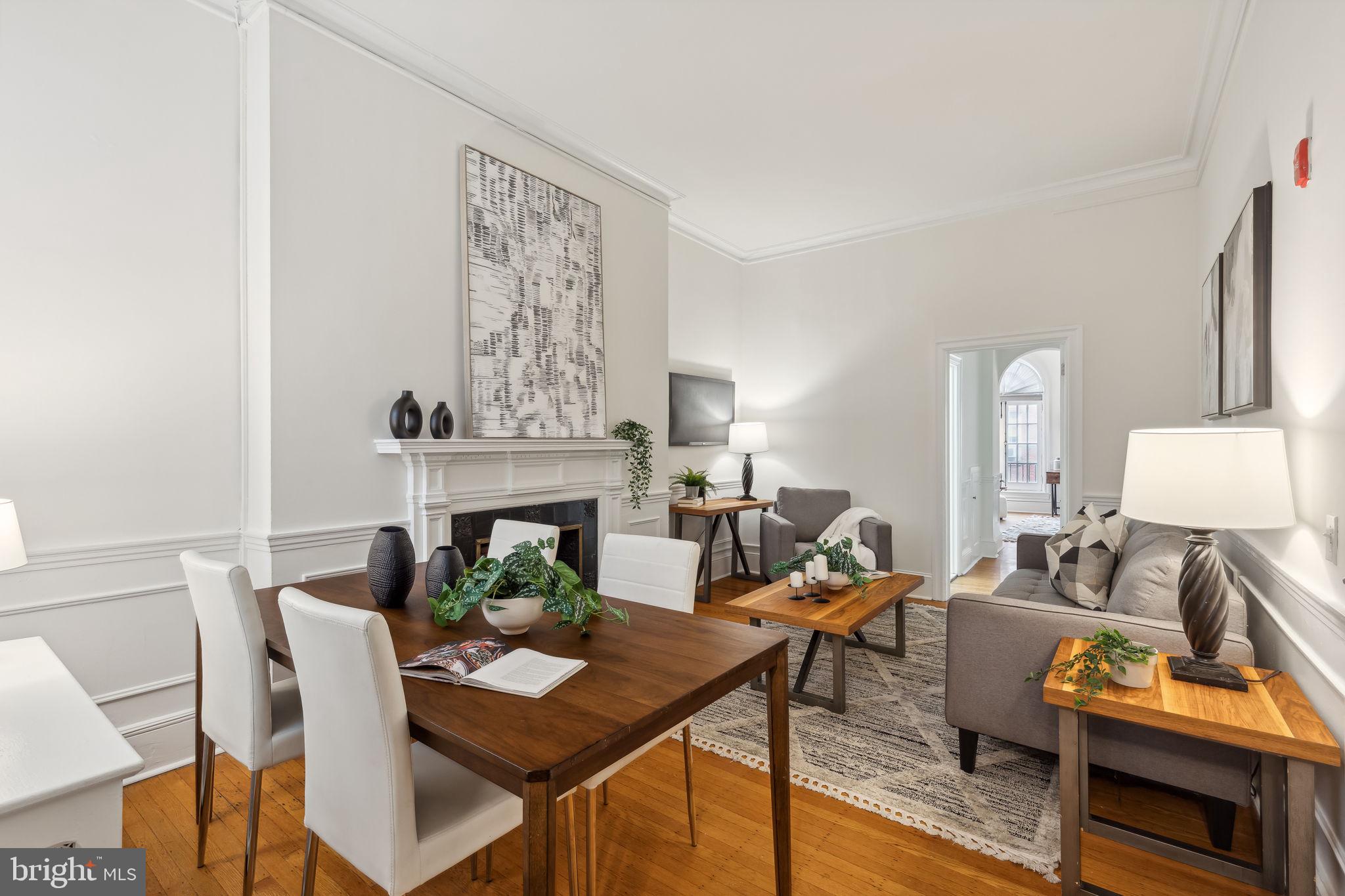 Discover historic Philadelphia charm in this 1 bedroom condo, perfectly placed just minutes from all the action. Located on the second floor, in a grand early 20th-century building commissioned by renowned real estate developer George T. Sale, you'll love the period details: two marble mantels, elegant wainscoting, built-in shelving, archways and French casement windows that flood the space with natural light as the original hardwood floors bring warmth and authenticity. You'll love the space in the Living/Dining combo too. The photos show a full size dining table and couch!
The updated galley kitchen offers ample storage and modern amenities including a dishwasher and gas range. A preserved 1920s bathroom retains its vintage character with the pedestal sink, tile surround and tub shower.
The spacious bedroom features dual closets with built-ins, sophisticated shelving, and a striking marble mantel with historic tile. Two casement windows brighten the room, which easily accommodates a king-size bed, side tables, dresser, and desk. Charming Juliette balconies add a European touch.
This sophisticated pied-Ã -terre enjoys an enviable location just blocks from Midtown's dining scene, one block from Broad Street's Avenue of the Arts, and a short stroll to historic Washington Square Park. This rare offering combines authentic period details with modern conveniences in one of Philadelphia's most desirable neighborhoods.