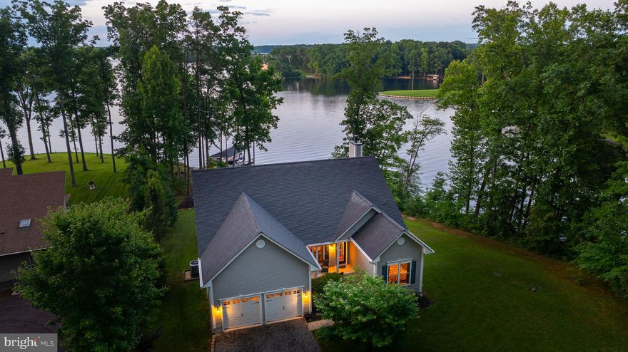 Nestled along the serene shores of Lake Anna, Virginia, this waterfront retreat on the public side of the lake, offers unparalleled tranquility and comfort.  This exquisite property epitomizes lakeside living at its finest with captivating water views, and extensive hardscaping that leads to the deep water boathouse (10 feet at the end of dock) and seamlessly blends with the natural landscape. 
 Situated on a prime waterfront lot with approximately 300 feet of rip-rap shoreline.  This home offers breathtaking vistas of Lake Anna from almost every angle, inviting you to unwind and immerse yourself in the beauty of your surroundings.  Cul-de-sac location and sitting perfectly on a .92 acre lot with high speed fiber internet!  Step inside, to this 4 bedroom, 3 full bath retreat that offers over 3,700 square feet with a partially finished walkout basement.  The main level features a family room with vaulted ceilings, wood burning fireplace and panoramic views of the lake, allowing natural light to flood the space and create a warm and inviting ambiance.  The kitchen is open to the family room and offers sleek granite counters, tile backsplash, breakfast bar and breakfast room with a bay window.  Separate dining room.  When it's time to unwind, retreat to the comfort of your main level lakeside primary suite that features a walk-in closet, tile shower, soaking tub, separate vanities and direct access to the back deck.  Additional bedrooms and bathrooms provide ample space for family and guests, ensuring everyone feels right at home.  Partially finished basement with a large family room/rec room, bedroom, full bath, a ton of storage.  Stepping outside, you're greeted by a paradise for water enthusiasts.  The premium waterfront lot ensures unparalleled access to the lake, while the covered boathouse with composite decking beckons with deep water, a storage room, 2 jets ski lifts and a convenient electric boat lift, perfect for launching aquatic adventures at a moment's notice.   Additionally, the sun deck at the boathouse offers an ideal spot for soaking up the sun or enjoying evening cocktails against the backdrop of spectacular sunsets.  Great lake location close to Elk Creek Country Store & gas station, Lake Anna Taphouse, local dining, vet clinic & New Bridge Landing Shopping Center, where you'll find groceries, ABC, Verizon store, a nail salon, and more.  Don't miss your chance to experience the ultimate lakeside lifestyle—schedule your private showing today!  Many items convey!  See list of improvements and exclusions in MLS documents section.