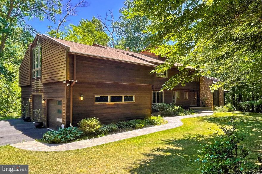 This exquisite and unique custom built made up of brick and Red Wood on a  five-acre estate is in the heart of Old Town Clifton. Tucked away in privacy, yet so close to historic town, restaurants and shopping. Offering a captivating fusion of contemporary living and outdoor retreat. Perched in a private cul-de-sac, an impressive tree-lined driveway leads to this stunning home. The 7000+ square feet of living space have been utilized brilliantly, ensuring that every inch of this home is utilized to its fullest potential.  The main house was custom built from the studs up, seamlessly integrating nature and the outdoors into a home that graciously welcomes all. Open the front door and you will be immediately met by the custom spiral staircase, inviting ambiance and the abundance of natural light that fills every room.  The spacious and thoughtfully designed layout features 5 bedrooms and 4.5 bathrooms, providing ample space for both relaxation and entertainment. The perfectly planned kitchen has a beautiful picture window overlooking the greenery.  The kitchen has ample room for creating fabulous gourmet meals, with stainless steel commercial grade appliances, center island, two sinks, custom cabinets, and plenty of storage. Adjacent to the kitchen, you will find a cozy breakfast nook, ideal for enjoying casual meals with loved ones. The living areas are designed with comfort in mind, offering a perfect balance between elegance and coziness. The family or music room is a great place to relax and unwind, featuring high ceilings, a beautiful fireplace and all the natural light. Additionally, there is a formal living room that provides panoramic view of the backyard. The Primary Bedroom is a true sanctuary, providing a peaceful retreat from the outside world. It boasts gorgeous natural light, a walk-in closet and a newly remodeled Primary Bathroom with a soaking tub. The other bedrooms are equally well-appointed, offering comfort and privacy for family members or guests. The Jack and Jill bathroom has a very unique hideaway loft for those slumber parties. There is an extra large living space on the second floor that has unlimited potential for your family.  There is a large finished basement with a walkout to the backyard. Step outside to the backyard oasis, where you will discover a private haven for relaxation and outdoor enjoyment. Whether you are hosting parties or BBQ on one of the two spacious decks or playing games on the low maintenance lawn, this backyard is a perfect extension of the indoor living space.  The property is conveniently located near schools, parks, delicious restaurants and shopping centers providing easy access to everything you need for a comfortable lifestyle.