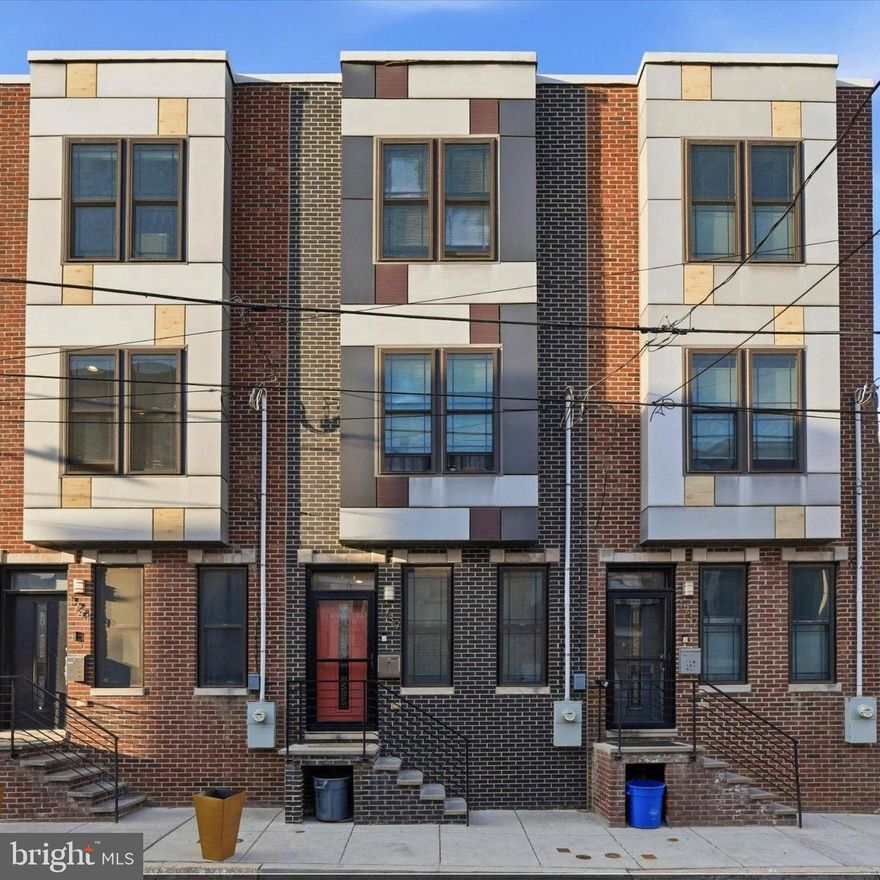 Stunning 8 year young townhome in the heart of Francisville! This beautifully appointed home is filled with desirable upgrades, including rich hardwood flooring, elegant bullnose corner walls, recessed lighting, and oversized windows that flood the space with natural light. The open concept main level features a spacious living room with built-in speakers, seamlessly flowing into the dining area. The updated kitchen is a chef’s dream, complete with granite countertops, stainless steel appliances, tiled backsplash, under-cabinet lighting, and abundant cabinetry and prep space. Sliding doors lead to a private rear patio, ideal for relaxing or hosting guests. Upstairs, the second floor offers two generously sized, light-filled bedrooms with ample closet space and a beautifully finished full bath with custom tile, tub, and shower. The entire third floor is dedicated to a luxurious primary suite, featuring a walk-in closet, tray ceiling with ambient lighting, and a spa-like bath with a frameless glass stall shower. Just outside the suite, a convenient wet bar leads to the expansive rooftop deck, outfitted with built-in lighting and speakers, an incredible space to unwind while enjoying the views. The fully finished basement adds even more versatility, complete with a full tiled bath and egress, perfect for a fourth bedroom, home office, gym, or additional living space. Additional highlights include a surround sound system and 2 years remaining on the tax abatement, offering significant tax savings. Just steps from Girard Ave, Broad Street, Ingersoll Park and plenty of area shopping plus a quick commute to Center City in under 10 minutes via nearby public transportation.  Don't miss out on this well built, move-in ready home.