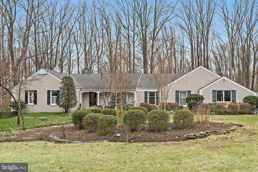 Nestled in the desirable community of The Meadows, this elegant brick-front home offers a perfect balance of space on 2.5 acres with functionality and refined details. Designed for both comfortable living and effortless entertaining, it gives an inviting open-concept layout that seamlessly connects the family room to the gourmet kitchen. The kitchen is a chef’s dream, featuring stainless steel appliances, dual convection ovens, granite countertops, and an oversized island with seating. The Kraftmaid cabinetry includes a double pantry cabinet with pull-out drawers and under-lit glass-front cabinets. A beautifully designed cabinet wet/dry bar with a wine cooler, wine rack, and instant hot water at the oversized sink—perfect for entertaining. Off the kitchen, the formal living and dining area showcases stunning travertine stone flooring, while an immense bay window floods the space with natural light, creating an inviting atmosphere. The main level also includes a spacious laundry and mudroom with a convenient rear door, a huge coat closet, and garage access. Designed shelving maximizes storage and functionality, making daily tasks effortless. Primary Suite Retreat offers a true sanctuary with a sprawling 12x12 walk-in closet, custom-designed by California Closets for optimal organization. The spa-like primary bath features dual sinks, an air-soaking tub, an oversized separate shower, and a private water closet with a bidet, all elegantly accented by marble tile flooring. The finished basement expands the home's living space with multiple outdoor access points leading to an expansive clubroom. Built-in bookshelves and cabinetry make this space ideal for a pool table, media center, or gaming area with surround sound. A flexible bonus room offers versatility as a home gym, craft space, or private office. At the same time, a custom-designed utility and hobby area is outfitted with specialized wiring and a commercial-sized sink—great for pottery enthusiasts or even dog-washing. Additional climate-controlled storage ensures ample space for seasonal items and household essentials.
Stepping outside, you'll find beautifully hardscaped grounds, including a 1,407 sq. ft. multi-level stone paver patio and a Trex deck off the kitchen—perfect for grilling and outdoor gatherings. The professionally landscaped gardens are maintained with an underground sprinkler system, ensuring vibrant greenery year-round. Parking is a breeze with an oversized side-entry two-car garage (613 sq. ft.) featuring a custom organization system and an additional parking pad designed to accommodate guests and oversized vehicles. An owned propane tank fuels the gas fireplace, gas range, and a full-house generator, adding energy efficiency and peace of mind. With a prime location offering easy access to Baltimore, Annapolis, and Washington, D.C., this exceptional home delivers both luxury and convenience. Don’t miss the chance to make 1812 Millridge Ct. your own!