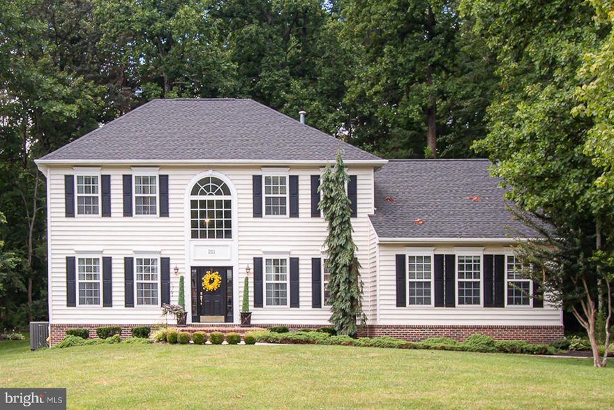 Please wear a mask while touring the home.  Bright and beautiful, impeccably maintained home updated over the years with pride by the original owners.   Located in an area with great school systems on  nearly an acre (0.91) of  land on a quiet street this stately, hip-roofed home offers 4 bedrooms, 2.5 baths, wide (11X10) and inviting two-story open entry foyer, gourmet kitchen,  formal living and dining rooms, library,  huge step-down  family room with cathedral and vaulted ceilings and fireplace,  leading to large (23x16) covered  rear porch  with high ceiling and deck, and 2-car side-load garage. Lower level has a large rec room,  exercise room, huge storage and utility areas and walk-up  exit to the  rear yard.    The beautiful foyer has wainscoting, wide crown molding, and 18X18 porcelain flooring.  Dining room has plush carpeting, wainscoting, wide crown molding,  and double windows with  faux wood blinds. Living room has plush carpeting, wide crown molding, and lots of windows with faux wood blinds. Kitchen has Silestone counter tops, double undermount stainless steel sinks, island with GE Profile cooktop, downdraft and breakfast bar, GE wall oven and built-in microwave, Samsung refrigerator, eating area with bay windows, pantry , built-in desk, and hardwood flooring.   Gorgeous  (27X18) family room has hardwood flooring, two ceiling fans, recessed lighting, wall of Palladian and transom windows with faux wood blinds, and atrium door to rear porch with built-in blinds. There is wainscoting on the main level hallway leading to the kitchen and on the wall of the stairway leading to the upper level.  Primary bedroom has quality carpeting, walk-in closet, and windows with faux wood blinds. Renovated  primary bath has large corner soaking tub, glass door shower with floor to ceiling tile, separate vanities, tile flooring and windows with faux wood blinds.  Upper level has three additional spacious bedrooms and a renovated hallway bath with tub shower with glass doors. Lower level rec room and exercise area have berber carpeting and recessed lighting.  Rear yard has fire pit and storage shed.  Recent updates are:   2020- new 3/4 HP submersible well pump;  2019- new roof ( CertainTeed),  new refrigerator (Samsung),  and large attic fan;  2017- remodeled upper hallway bath, new water heater(AO smith 75 gallon); 2016-new front door & large picture window above front door and side windows, updated powder room,  and replaced sewage pump;  2015- new high efficiency HVAC system (Trane),  repaved the driveway,  and renovated primary bath; 2014 - replaced garage door.   All dimensions are approximated.