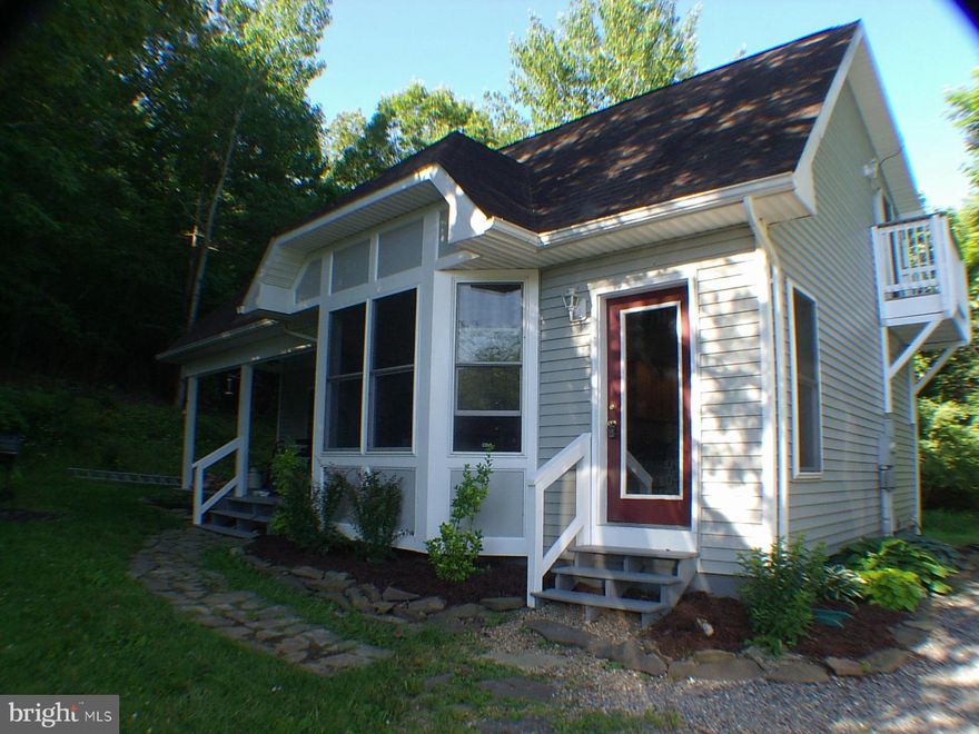 Wonderful  home on 5 acres with privacy and seclusion.    Beautiful bay window in front increases the  views.   Nice propane fireplace makes the home extra cozy in cooler weather.  As soon as you step in, you see the beautiful  stairway going up to the loft room.  Great Microwave oven also has the convection feature for browning.  Salt box style home makes more room upstairs for a  bedroom, full bath and a 20 ft long loft room with balcony.  Plenty of wildlife. Deer seen almost every day, Wild turkeys seen often, and Bald Eagles seen occasionally. Renovation now complete to put this home in tip top condition. Home has 2 bedrooms and 2 baths.  Septic is rated for 1 bedroom.  Property has 2 nice outbuildings.  Full 1 year Home Warranty with sale of home . Call listing agent first just to clear showings.