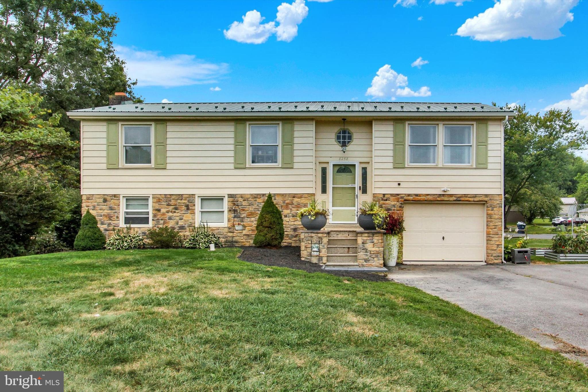This well-maintained bi-level home is situated on a 0.22-acre corner lot. The property offers three bedrooms, one and a half bathrooms, and a fully finished basement for additional living space. An attached garage and large driveway provide ample parking. Enjoy outdoor living on the deck and easy access to nearby parks, schools, and local amenities.