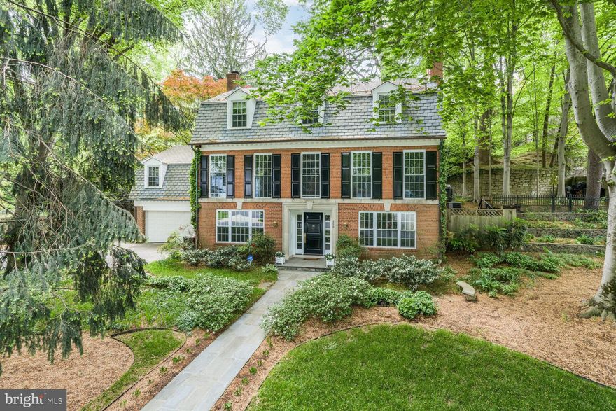 Experience the best of Washington living in this stunning 4-bedroom, 4-bath Dutch Colonial, ideally located in prestigious Spring Valley on one of the neighborhoods favorite blocks. Built in 1961, this elegant home spans nearly 4,000 square feet across three beautifully appointed levels, featuring timeless details such as hardwood floors, crown molding, multiple fireplaces, and abundant natural light throughout.

Step into the gracious entry foyer which leads to the entry-level bedroom suite with full bath, recreation room/play room with a wood-burning fireplace, laundry #1, and garage access. On the main level, enjoy an expansive formal living room with fireplace, a sophisticated dining room, and a private study with custom built-ins and French doors that open to a charming walk-out patio and lush backyard. The thoughtfully designed kitchen connects seamlessly to a bright family room with full bath and laundry #2.

The upper level features a luxurious primary suite with an updated bath and walk-in closet, two additional bedrooms, and hall bath. Complete with a two-car garage, refined formal spaces, and comfortable family areas, this exceptional residence delivers both elegance and comfortable everyday living. Residents of Spring Valley enjoy neighborhood shops and restaurants including Millie's, Pizzeria Paradiso, Compass Coffee, Starbucks, Wagshal's market, CVS, Crate & Barrel and more! This location offers an easy commute to downtown Washington, Maryland, and Virginia, as well as all area airports.