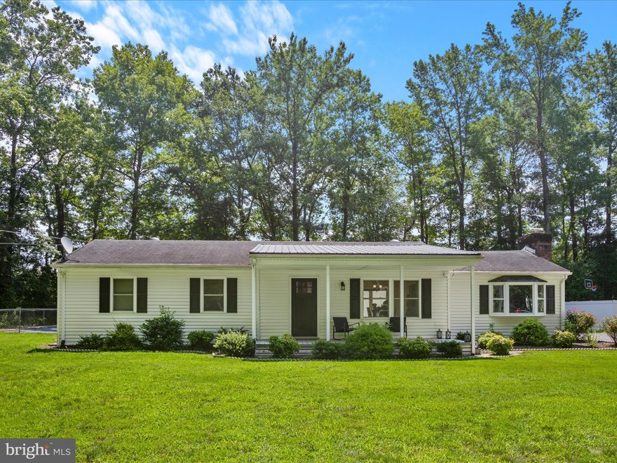 Welcome to 26831 River Road ,  a beautifully renovated rancher offering timeless charm, modern updates, and a peaceful setting in Seaford.

Set back from the road and surrounded by mature trees, this inviting home welcomes you with a lovely front porch, perfect for sipping coffee and taking in views of the lush front lawn. Step inside to discover gleaming hardwood floors in the spacious living room, creating a warm and welcoming ambiance.

Just a few steps down, the cozy family room awaits, featuring a classic brick fireplace and a large Bay window that fills the space with natural light—an ideal spot for quiet evenings or relaxed gatherings.

The heart of the home is the bright and functional kitchen, complete with crisp white cabinetry, sleek granite countertops, and stainless steel appliances. Space for a table offers casual dining while sliding glass doors lead to the expansive back deck, making outdoor dining and weekend barbecues a breeze.

At one end of the home, you’ll find three comfortable bedrooms and a full bathroom, offering ample space for rest and retreat. An additional full bath is conveniently located near the family room.

Outside, the backyard is designed for enjoyment and entertaining. The large composite deck is ideal for al fresco dining, while the stone patio creates a perfect space for a fire pit or outdoor lounge. The in-ground swimming pool adds a touch of resort-style living—whether hosting summer pool parties or simply relaxing in your private oasis. The fully fenced yard ensures privacy and safety, making it perfect for pets or children to play freely.

Additional features include a two-car garage with an attached storage area, ideal for tools, lawn equipment, or hobby space.

Don't miss this opportunity to own a move-in-ready, stylishly updated home in a serene setting, your perfect blend of comfort, function, and outdoor living.