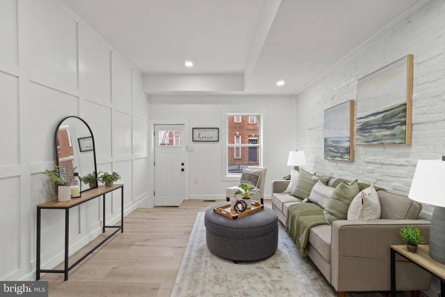 Completely renovated Pigtown townhome on a quiet street—where modern finishes meet worry-free living. This brand-new renovation features all new windows, HVAC, plumbing, electrical, appliances, flooring, and fresh paint throughout, offering true turnkey peace of mind. -The open main level flows effortlessly from living room to kitchen to dining area and is anchored by a stunning, high-end backsplash and sleek finishes that elevate the space.  Upstairs, you’ll find two spacious bedrooms with two full bathrooms and a balcony off of the back bedroom overlooking a field.  The lower level offers generous bonus space—perfect for a workshop, home gym, storage, creative studio, OR A THIRD BEDROOM. -Out back, enjoy a brand-new fenced patio, ideal for relaxing, entertaining, or letting a pet roam—rare and valuable city outdoor space. -Located in vibrant Pigtown, close to parks, dining, stadiums, and major commuter routes, this home delivers style, function, and long-term value in one of Baltimore’s most convenient neighborhoods. -Move in and enjoy—everything is already done.