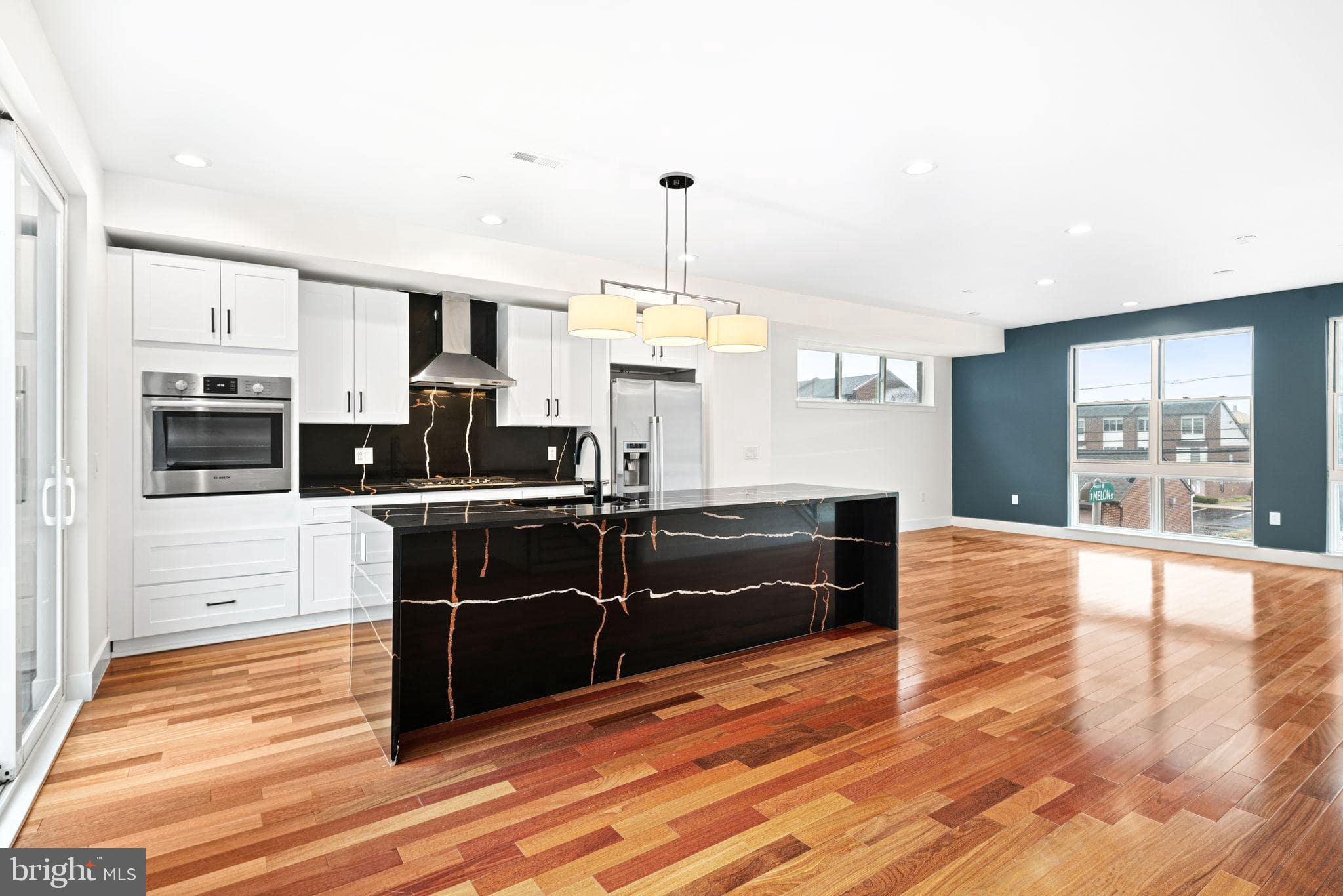 Be the first to live in this stunning new construction luxury home with 2 CAR PARKING in one of Philadelphia's hottest neighborhoods. Over 2500 Square feet of beautiful modern details. Statement-making lighting pieces hover proudly as you enter the first floor where you’ll find a bedroom, full bathroom, and bright office area. Wood flooring, designer light fixtures, and strategically placed accent lighting are just a few of the high-end features that adorn these homes. Heading upstairs you will find the open concept floor plan that allows the living and kitchen areas to blend seamlessly together. Exploring every corner of this floor, you will discover convenient features designed for entertaining and everyday life. The kitchen area features a quartz island with optional elegant under-counter lighting and tambour paneling, GE appliances, and soft close cabinetry. To create intimate evenings with family or friends, opt for the built in Sonos speaker system, smart lighting controls to dim the lights, and craft a cocktail at the built-in beverage & wine station. Then open the sliding doors off the living area to your second floor patio to enjoy an evening under the stars, a space perfectly suited for morning pastries and coffee to grilling and cocktails. The third floor bedrooms are bright open spaces. Entering the main bedroom you’ll love the spa-like bathroom with finishes thoughtfully selected by professional designers, optional heated floors extending into the shower, and a frameless glass shower. Finally, the fourth level is your outdoor oasis– a 400+ sq ft deck with views of Center City and Northern Liberties.