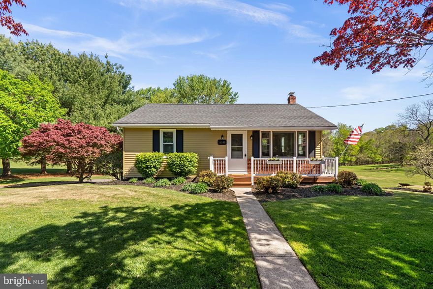 Welcome to 16048 Ed Warfield Road—a beautifully maintained rancher set on a picturesque one-acre lot where privacy, open space, and thoughtful indoor-outdoor living come together in a truly special setting.    From the moment you arrive, the inviting front porch sets the tone for the warmth and charm found throughout the home. Step inside to a bright and welcoming living room featuring hardwood floors, crown molding, and recessed lighting, creating a comfortable space for everyday living. The flow continues into the kitchen, where granite countertops, a center island, and a dining area provide both function and gathering space for friends and family.  Just beyond, the family room/sunroom is the true standout features of this home. Finished with new carpet, a vaulted ceiling with exposed beams, abundant natural light, and a wood stove, this space offers itself as a warm and inviting retreat in every season. From here, step out onto the deck, where stairs lead down to the backyard and open views beyond.   The main level includes a primary bedroom with crown molding, an additional bedroom, and a full bathroom, all thoughtfully arranged for comfortable one-level living.    The finished lower level significantly expands the home’s versatility, featuring a recreation room with built-ins, an additional/optional bedroom, and a bonus room that could serve as a home office, exercise room, or potential fourth bedroom. A full bathroom, laundry/utility room, and walk-out access to the rear patio add both convenience and flexibility. Step outside to enjoy the patio with a hot tub, perfectly positioned to take in the peaceful setting while maintaining privacy.   You'll find a very private and spacious room under the rear sunroom (only accessible from the exterior of the home) that has been used for both a workshop and secure storage. It is both dry and cool, ideal for storing anything from wines to outdoor items to furniture.  The property is truly spectacular - set on a beautiful one-acre lot, the expansive yard offers privacy, open views, and plenty of space for gardening, recreation, or simply enjoying the outdoors. An OVERSIZED DETACHED GARAGE (1040 sq ft!!) features a 552 sq ft workshop space is a true rare and valuable bonus—ideal for hobbyists, storage, an in-home business or those in need of true workspace.     Located in sought-after Woodbine, this home offers a wonderful balance of rural charm and convenience. Enjoy close proximity to Western Regional Park, local farms, golf courses, and equestrian amenities, while remaining within easy reach of Route 70, Route 94, and Route 32 for convenient access to Frederick, Columbia, Baltimore, and surrounding areas. Nearby shopping, dining, and everyday conveniences are just a short drive away, while the setting itself offers the peace and space that make Woodbine and this home so desirable.    A rare combination of land, privacy, flexible living space, and a true workshop property—16048 Ed Warfield Road offers a lifestyle that is increasingly hard to find!