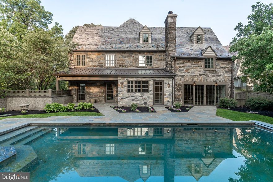A beautiful custom home that was designed and built for one of Center City's top luxury townhome developers, now available! Rehabbed from top to bottom, the developer built the home originally intended for personal use but has since decided not to move, offering you the opportunity to enjoy top of the line, custom finishes and features throughout! Some of these fabulous features include 7 inch baseboards, rich hardwood flooring, custom molding, in-ceiling speakers installed throughout the home, three zoned HVAC and much more! This gorgeous corner property with detached two car garage immediately impresses with its real slate roof, stone facade, and unbelievable mature landscaping with lovely trees surrounding the home. The first floor welcomes all with its lovely foyer with beautiful maple staircase and solid maple handrails, and continues to delight with every room. The living room is ready and waiting to host your favorite guests, with its custom ceiling, open wood burning stone fireplace, custom bar with wine racks, in ceiling speakers and access to the exterior porch. Continue through the first floor to admire the elegant dining room with two full glass doors leading to the impressive blue slate pool deck which leads to a beautiful, heated pool with stone walls- ready and waiting for some morning laps, or for swim parties with your favorite guests. The first floor also features a wonderful family room with custom lighting, 11 inch sliders leading to the pool deck and an impressive stone, gas burning fireplace to keep you and yours warm and comfortable on cooler evenings, as well as a sunroom with 3 skylights- just the spot for your morning cup of coffee or Sunday morning breakfast. Be sure to also take a look through the fantastic kitchen, complete with quartz counters, custom island and backsplash, a Wolf 48 inch range with custom hood, Subzero 48 inch refrigerator, Boshe dishwasher and Sharp microwave drawer. The kitchen also includes a beverage center to store your favorite drinks, and has a full light door also leading to the pool deck. Upstairs, the second floor reveals a master suite that is sure to please, with its custom tiled gas fireplace, extra large walk-in closet, sitting area and a master bath that offers a spa-like experience with custom vaulted ceilings, tiled radiant heated floors and custom tile 48 inches up the walls, a custom double vanity with lighted bridge, side towers and vessel sinks, not to mention also the Toto in-wall toilet, soaking tub and custom tiled shower with dual shower heads and frameless glass enclosure. The master bath also has additional linen closets, so storage shouldn t be a problem. The second floor also includes a lovely laundry room for your convenience, and a spacious, light filled secondary ensuite bedroom a full custom tiled bathroom, as well as another elegant, spacious bedroom with the same gorgeous details throughout and another custom tiled full bathroom. Discover the two light filled bedrooms and a fabulous open space on the third floor, with vaulted ceilings, custom closets, installed speakers, and custom tiled bathrooms with Toto toilets, exquisite showers with frameless glass enclosures and much more. For those who still need a little extra indoor space, the finished basement is sure to meet your needs, with its custom bar with tiled flooring, lighted mirrors and quartz countertops, as well as its TV area with surround sound set-up with carpeted flooring. This home is also smart home ready, which can be extended by any buyer. Found close to the train and all that Bryn Mawr has to offer, this is definitely a home you don t want to miss!