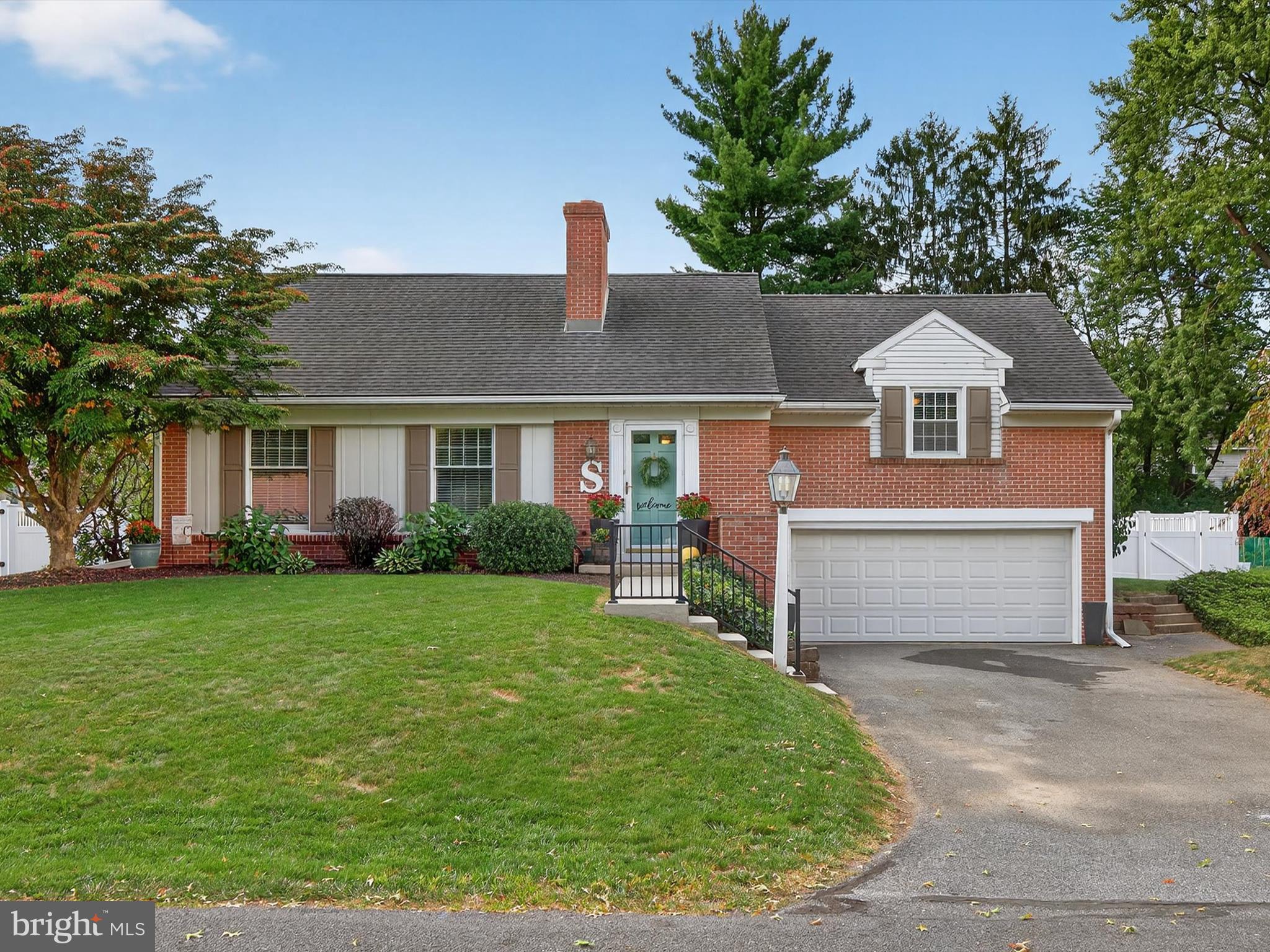 Welcome to 31 Sunset Avenue in Manheim: a charming home built in 1964, nestled on a
spacious 0.28-acre lot, offering space, comfort, and timeless character. Step inside and find the
living room to the left of the entryway, where a classic brick fireplace with mantel creates the
perfect focal point. Hardwood floors, crown molding, and large windows fill the room with
warmth and light, while built-in shelves by the staircase add both charm and function.
Through the doorway, the dining room continues with gleaming hardwood floors, expansive
windows, and elegant lighting—an inviting space for entertaining. From here, step into the
sunroom, a true oasis with a lofted ceiling, plush carpet, calming tones, and surrounding
windows that flood the room with natural light. Enjoy a quiet morning coffee here as the sun
rises, or step outside to the brick patio for backyard grilling and al fresco dining. The yard is
fully enclosed with a shed and beautiful privacy fence, perfect for gardening, gatherings, or play.
The kitchen features ceramic tile flooring, hardwood cabinetry, and plenty of counter space,
making it both functional and stylish. Around the corner, you’ll find access to the basement and a
discreet and convenient laundry area. Just a few steps up are two generously sized bedrooms and
a full bathroom—ideal for guest accommodations, a home office, or flex space.
Upstairs, the private primary suite offers hardwood floors, a spacious closet with dressing area,
and a full bathroom with walk-in shower. A large attic storage area completes the upper level.
Down to the basement, there is a sprawling family room with beautiful wood beams, a second
fireplace, and loads of storage. More storage is available in the 2-car garage. This Manheim
home is a home filled with character, natural light, and versatile spaces. And it’s ready to
welcome you home.