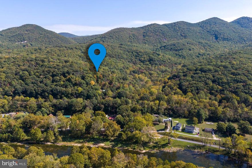 Nearly an acre of peaceful solitude in Shenandoah Gap! Short-term rentals are allowed and there is community access to the Shenandoah River, Shenandoah National Park, and a 400+ acre nature preserve. A new survey has been completed and property corners have been marked by a licensed surveyor. Health department records indicate septic and cistern on property, condition is unknown. All improvements are sold in strictly "AS IS" condition.  Seller will not make any repairs whatsoever.  Structure on the property is in poor condition, DO NOT enter structure. Structure is not in compliance with the HOA declaration, rules, and bylaws and must be repaired or removed within six months after closing to bring into compliance. Sale is subject to the approval of the Page County Circuit Court.  All offers are due by Tuesday 10/24/2023 at noon.