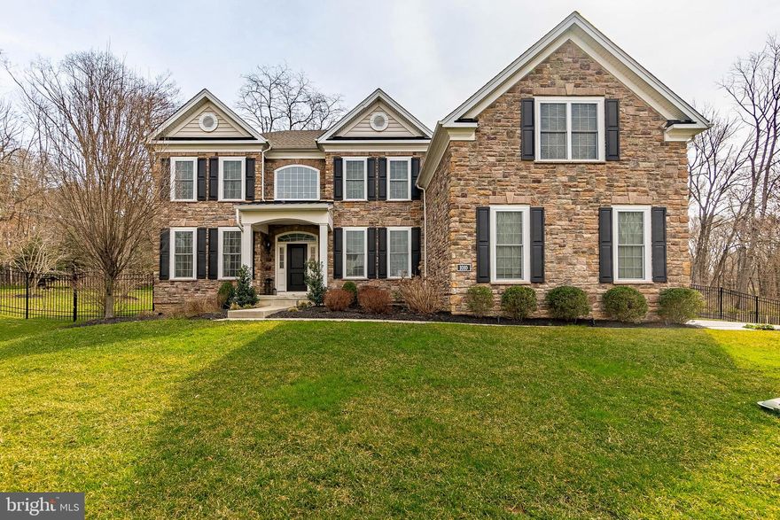 Welcome to 1010 Hatches Mill Drive, a stunning 5-bedroom, 4-bathroom home nestled on a sprawling 1.20-acre lot in the charming town of Media. Boasting a fenced yard and a 3-car garage, this residence offers both space and style. As you step inside, you'll be greeted by a grand 2-story foyer adorned with gleaming hardwood floors and a curved staircase leading to the upper level. The elegant living room features hardwood floors, crown molding, chair rail, and wainscoting. The formal dining room offers an inviting atmosphere for gatherings. Prepare to be amazed by the spacious and gorgeous kitchen, complete with granite countertops, a tile backsplash, an island with seating and pendant lighting, stainless steel appliances, and a pantry. The breakfast room, featuring hardwood floors and a slider to the patio/yard, is the perfect spot for enjoying morning coffee or casual meals. Open to the kitchen is the family room, which offers hardwood floors, tall ceilings, and a cozy gas fireplace ideal for relaxation and entertaining. Conveniently located on the main level is an office or bedroom with a bathroom, accessible from both the bedroom and the family room.  A mudroom completes the main level. Retreat to the upper level where you'll find the luxurious primary bedroom boasting crown molding, three walk-in closets, a sitting area, and an en-suite bathroom with tile floors, a shower, a soaking tub, two vanities, and a water closet. Three additional bedrooms, a laundry room, and two full baths with tub/shower combinations and tile floors can also be found on the upper level. The walk-out basement has been thoughtfully finished to offer additional living space, including a media room, exercise space, and a bar area with a refrigerator and quartz countertop, perfect for hosting gatherings. A storage room provides ample space for organization. Located in a great neighborhood close to local parks, attractions, major roadways, restaurants, and shopping, this home offers the perfect blend of comfort, convenience, and luxury living. Don't miss your chance to make this dream home yours!