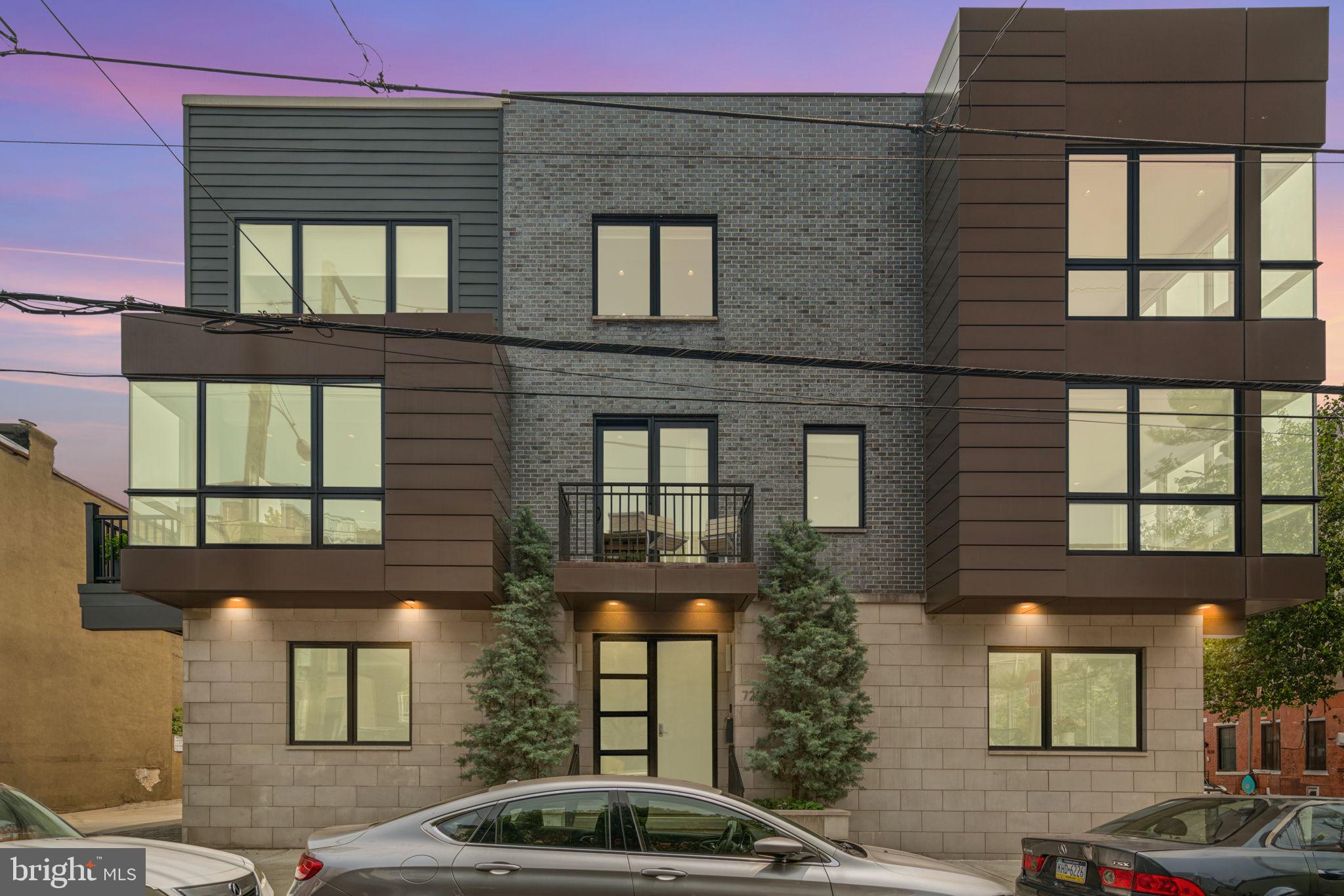 725 S 19th Street is a one-of-a-kind modern residence in the heart of Graduate Hospital offering 3 bedrooms, (4th BR easily added in finished lower level), 3 full bathrooms, 3,500+ sq ft of interior living space, and over 1,300 sq ft of outdoor space. Spanning the entire northeast corner of 19th & Fitzwater Streets, this extraordinary home stretches an impressive 71 feet wide—an almost unheard-of offering in Philadelphia. Also included is an oversized 2-car garage plus a driveway space for a total of 3-car parking.
Inside, a dramatic open steel & oak staircase connects sun-filled living and dining areas with a custom three-sided glass fireplace, and a chef’s kitchen with Wolf, Sub-Zero & Miele appliances, enormous stone island, and two outdoor terraces. The 3rd level includes the luxurious primary suite, and a spa-like bath with soaking tub, triple-head double glass shower, and generous closets. An expansively finished lower level has a custom wet bar, wine storage, laundry room and flexible space ideal for a home theater, gym, or family room—and can very easily accommodate a 4th bedroom. At the top, a full pilot house with kitchenette opens to an expansive roof deck finished in porcelain pavers, offering true 360° panoramic views—river to river, sunrise to sunset, and the city skyline illuminated at night. All just blocks from Rittenhouse Square, Schuylkill River Park & Trails, and Center City’s best dining and culture. Open House Sunday Sept. 7th from 12 to 1:30 PM. Floorplan, video and detailed improvement list is available.