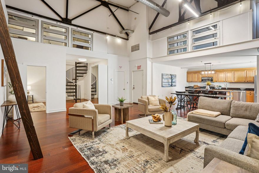 LOW FEES & 2-CAR HEATED PARKING INCLUDED! Fees cover heated parking, water, trash & management — an incredible value. Welcome to 810 N Hancock Street, where industrial sophistication meets limitless creative living in the heart of Northern Liberties! Formerly a warehouse, this extraordinary loft condo stuns with soaring 20+ ft ceilings, dramatic exposed brick walls, steel beams, and rich hardwood floors — a one-of-a-kind backdrop for your boldest ideas. Whether you're an artist, creative professional, or entrepreneur, this is your blank canvas. The monumental brick wall is gallery-ready hang large-scale artwork, install a rock climbing wall, or rig aerial equipment. Create your own personal training studio, design center, or work-from-home headquarters across multiple dedicated flex spaces, including a custom lofted nook with ladder access perfect as a studio, office, gaming lounge, or private retreat. Two upper-level bedrooms including a spacious primary suite with beautifully renovated en-suite bath, plus 3 main-level rooms ideal for guests, home offices, or creative use. Second full bath also fully updated. Off the kitchen, a sun-filled private deck is perfect for morning coffee or evening grilling, with shared rooftop access offering stunning Philadelphia skyline views. Rare 2-car heated garage parking and additional storage complete this inspiring home  expansive yet intimate, extraordinary yet livable. One block to Standard Tap, steps from Jerry's Bar, Urban Village Brewing, Café La Maude, and the speakeasy-style 637 Philly Sushi Club. Walk to ACME and Amazon Fresh. Easy Market-Frankford Line access to Center City. This space rewards imagination — come with a vision!