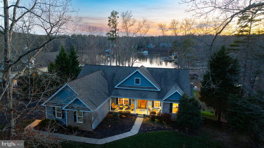 Nestled along the tranquil shores of Lake Anna in the sought after Freshwater Estates neighborhood, 110 Trevor Run beckons with the allure of waterfront living at its finest. This exceptional residence marries the charm of lakeside serenity with modern updates, offering an unparalleled retreat for those seeking luxury and comfort in a picturesque setting. Over 4,800 square feet with 5 bedrooms, 3 baths. Step through the doors to an inviting open floor plan that has been meticulously maintained and updated. This home seamlessly blends timeless elegance with contemporary convenience. Expansive family room with gleaming hardwood floors and vaulted ceilings that is open to the renovated gourmet kitchen that is a culinary enthusiast's dream, featuring quartz counters, new stainless appliances and an island. Whether preparing a family dinner or elaborate feasts, this well-appointed kitchen provides the perfect backdrop for culinary creativity. The open-concept floor plan flows effortlessly from room to room, making entertaining a breeze. Adjacent to the kitchen, a breakfast nook bathed in sunlight offers the ideal spot to start your day with a cup of coffee and views of the tranquil waters. With five bedrooms, including a luxurious master suite, there is ample space for family and guests to rest and recharge. Each bedroom offers its own unique charm. The master suite is a sanctuary unto itself, featuring a spa-like en-suite bathroom, with a tile walk-in shower, stand alone tub, double vanity and a dreamy custom California walk-in closet with shelving and drawers and also provides direct access to outdoor spaces where you can start your day with stunning views of the lake. Step onto the expansive covered deck and immerse yourself in the sights and sounds of waterfront living. The finished walkout basement provides a family room, theatre, bar, additional bedrooms and a full bath. Relax and have a glass of wine on the lower level patio in the 6 person hot tub or serve dinner in the screened porch, both overlooking the lake. Whole house generator, tankless water heater, 2 car garage, paved driveway, exterior lighting, fire pit and extensive hardscaping.  The rear yard is fenced making it the perfect place for your fur babies too! For those who crave adventure, take the slate path down to your private covered boathouse that has an electric boat lift, large sun deck and storage room for your lake toys with direct access to Lake Anna, where days are spent fishing, swimming, and exploring the endless possibilities of life on the water. Whether you're seeking a year-round residence or a weekend getaway, this exceptional waterfront home invites you to experience the best that Lake Anna has to offer. Don't miss your chance to make this extraordinary property your own and start living the lakefront lifestyle you've always dreamed of.  Too many improvements to list here. See list in MLS documents section.