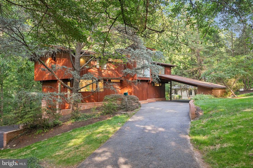 Stunning, unique contemporary, award winning design,  6 bedrooms/3 baths,  situated on 1.4 wooded acres contiguous to Potomac School.  Accessed via a very private road just beyond the entrance to the school.  Scenic wooded views from the back porch and interior spaces with soaring ceilings and large windows.  Step in the flagstoned foyer, where just beyond the dramatic Living Room space begins.  Perfect for entertaining, or large family gatherings,  with floor to ceiling windows and walk out to the patio with views of the very private wooded property.  Living room is spacious with abundant wall space for art and a wood burning fireplace.  Beyond the Living room is the intimate  Dining Room, which also looks out to the backyard through floor to ceiling windows.  Hardwood floors throughout.  All White chefs kitchen with streamline cabinets and a new subzero perfectly situated with a  pass through to the dining room.  Very spacious and cozy primary bedroom on main level, with wood ceiling and built-ins.  Plenty of storage throughout the home, and skylights to add extra light.  Four bedrooms and a large limestone bath are on the 2nd floor.  In addition to the bedrooms upstair, enjoy a stunning office/playroom space that looks over the living room and the 2 story cathedral ceiling.  The lower level is inviting and walks out to the garden.  Use as bedroom 6 for guests/aupair or family room, with wood burning fireplace and full bath.  A 2  car garage is entered into by the side of the home and connects to the lower level and laundry room.  Zoning is R-1,  Fairfax County.