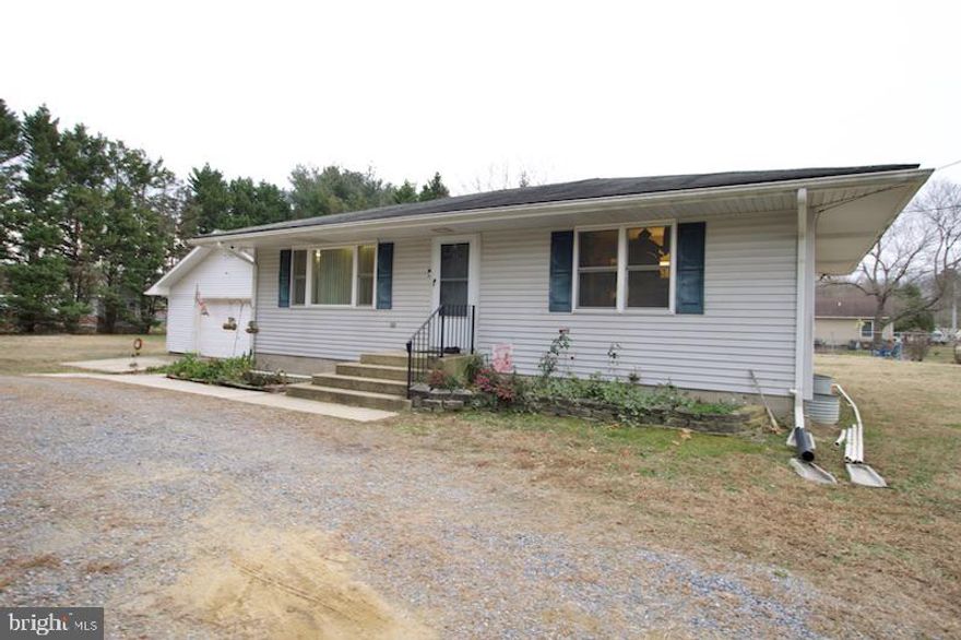 WOW!!!! ALL OF THIS  SITTING ON  a .68 ACRE LOT IN THE RURAL AREA OF MAGNOLIA.  This cute and cozy  little rancher with 2 large detached garages has tons of potential! This cozy little rancher offers 3 bedrooms 1.5 baths, a fully equipped kitchen with a full basement that has an emergency exit.  The home sits back off of the road behind a row of privacy trees.  The detached garages are great for storage or whatever your heart desires. The home is serviced by electric baseboard heat, window air condition units, a private well (no water bill) and it is connected to the public sewer line. Schedule your appointment soon and let your imagination take over! The home is being offered in "as is" condition. The Seller will not be making any repairs to the property.