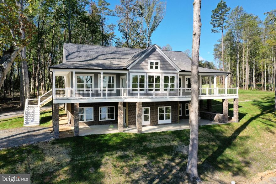 A beautiful brand new waterfront home nearing completion in Lake Anna's newest waterfront community, Compass Cove on Lake Anna.  Located on the private side of the lake, Compass Cove offers a peaceful setting with stunning water views.  This exquisite home, built by BT Construction Company INC, on LOT 55 is at the end of a cul-de-sac and has over 200+ feet of shoreline.  The builder also plans to build a single slip boat dock.  This custom built craftsman style lake retreat is over 4,300 square feet spread out over two levels, 4 bedrooms, 3.5 baths, and a 3 car garage with a room above!  Superior wall basements, black gutters and downspouts, LVP flooring, stainless steel appliances and composite decking.  This home features two primary suites; one on the main level and a second one on the lower level.  Don't miss the opportunity to experience the lake lifestyle in a brand new home!  See full list of builders scope of work, house plans, plat and site plan in MLS documents section.  This home sits on lot 55 and the lots have sign numbers in front of them.