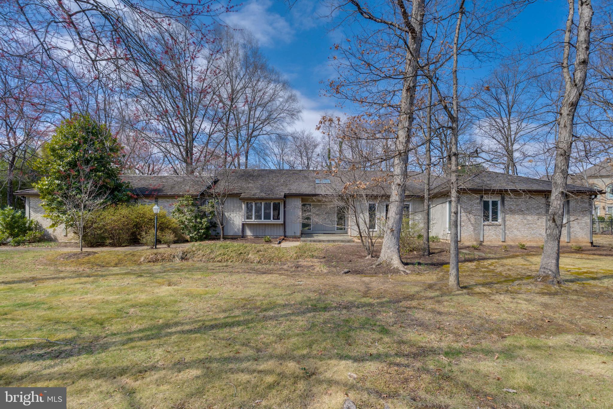 A true diamond in the rough, 10108 Ormond Road presents an extraordinary opportunity in the heart of Potomac Village, just a half-mile from the area's vibrant retail and dining center. Custom-designed and built in 1973, this timeless rambler-style home is being offered for sale for the very first time. Nestled on a picturesque 0.85-acre lot, the residence boasts over 3,600 square feet of main-level living space, with an equally expansive lower level, ready to be reimagined and personalized.
Designed to seamlessly integrate indoor and outdoor living, the home’s defining feature is a continuous wall of sliding glass doors that spans the entire back of the house— from kitchen through Great Room, den and primary suite. This integrative design ensures that nearly every space enjoys sweeping views of the expansive backyard, filling the home with natural light and a sense of openness.
A grand foyer welcomes you into the home flanked by a gracious formal dining room and an elegant formal living room. At the heart of the home, the Great Room impresses with vaulted ceilings, skylights, a fireplace, and seamless indoor-outdoor flow to an expansive patio, ideal for entertaining or quiet retreat.
The renovated kitchen features solid wood cabinetry, granite countertops, gas cooking and a center island, all opening to a skylit breakfast room drenched in sunlight with private backyard views.
The bedroom wing of the home offers exceptional space and versatility. A home office with a fireplace, adorned with a striking copper hood, serves as a quiet retreat with sliding doors to the patio and a private connecting doorway to the primary suite. The primary suite itself is large, offering the perfect footprint for a newly designed spa-like bath and an enviable walk-in closet. Down the hall, three additional generously sized bedrooms and two full baths provide comfort and flexibility. Rounding out the main level is a powder room, a spacious laundry/mudroom, and an oversized two-car garage, ensuring convenience and ease of living.
The lower level of the home is equally expansive, offering endless possibilities for recreation, work, or additional living space. A grand rec room, large enough to accommodate multipurpose areas, serves as the focal point of this level. Adjacent to it, a private den offers the potential to be transformed into a home gym or media room, while a separate bedroom suite with a full bath provides ideal accommodations for guests or extended family. Additional features include a cedar closet, multiple storage rooms, and a powder room for added convenience. The lower level can be accessed via two separate staircases from the main level as well as a walk-up exterior entrance, offering flexibility and privacy.
With its unmatched location, expansive layout, and limitless potential, 10108 Ormond Road presents a rare opportunity to transform a custom-built Potomac Village estate into a modern masterpiece, just moments from shops, dining, and major commuter routes.