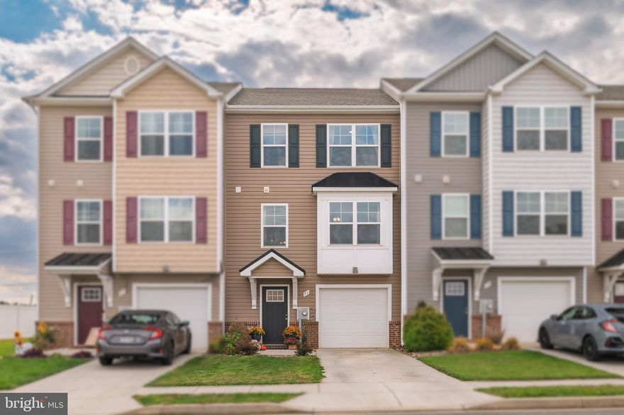 Step inside this inviting townhouse located in The Communities of Burwell!

The main level offers a large kitchen, oversized living room, and half bathroom. The kitchen boasts granite countertops, ample cabinets, a pantry for all your storage needs, and space for a table. The sliding glass door opens to a composite deck, which is perfect for grilling, casual gatherings, and catching the sunset. The living room is bright and spacious, offering a comfortable spot to unwind and plenty of room for a play area or desk. A conveniently located half bath adds extra ease for everyday living.

Upstairs are three spacious bedrooms and two full bathrooms. The generous primary suite stands out with a soaring vaulted ceiling, a walk-in closet, and a private bathroom with double vanity. The two secondary bedrooms each have a large closet, and share a full hall bathroom.

The entry level has an inviting foyer, with access to the 1-car garage and unfinished living space that has a full bathroom rough-in and door to the backyard.

This home brings comfort, space, and practical features in a growing community that is close to schools, shops, and major commuter routes.