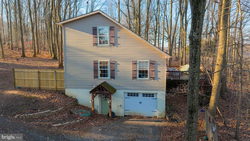 Tucked away at the end of a private lane, this cozy home is surrounded by woods and sits on over ¾ of an acre, offering privacy, peace, and room to enjoy the outdoors. The property allows for a chicken coop, making it ideal for those seeking a more rural lifestyle. The main level features a first-floor bedroom and full bath, along with an open living and dining area highlighted by a vaulted ceiling that creates a bright, airy feel. The kitchen is conveniently located just off the main living space, making everyday living and entertaining a breeze. Upstairs, you’ll find two additional bedrooms connected by a Jack-and-Jill bath. With its tranquil setting, functional layout, and flexible living spaces, this home is a perfect retreat while still offering practical comfort.  The seller is offering a $5,000 credit towards new flooring.