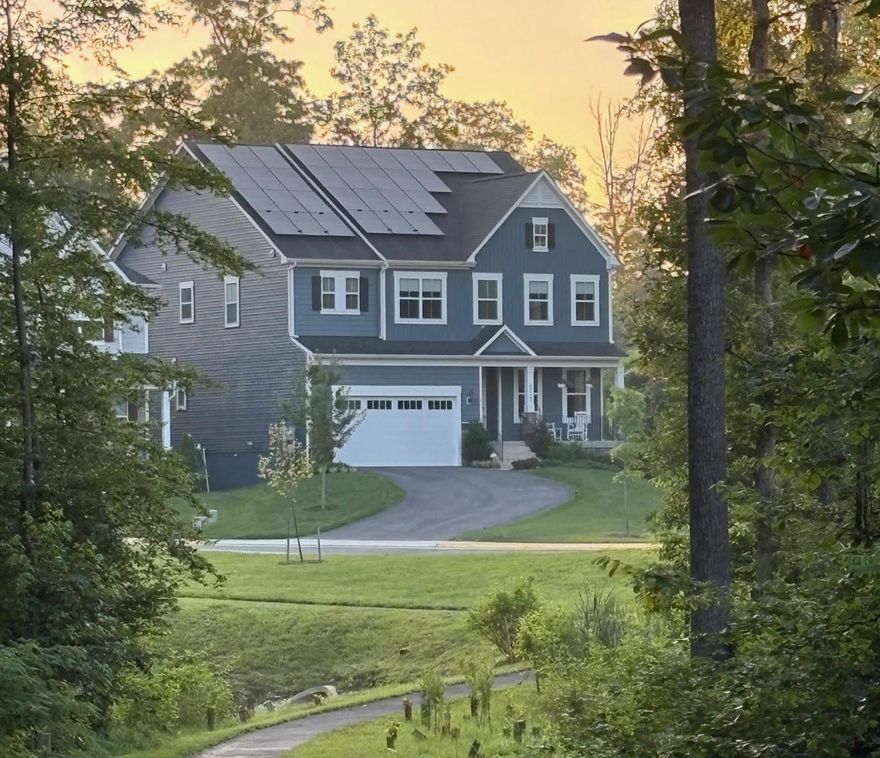 Four year young luxury home backing to protected trees in the heart of West Springfield.  Located within the top-rated West Springfield school pyramid and walking distance to shopping, restaurants, and community trails.  This beautifully upgraded Taylor model built by Christopher Companies offers privacy, modern design, and exceptional energy efficiency.   One of the standout features of this home is the fully owned 11.84 kW rooftop solar system , no lease or power purchase agreement.  Net-metered and producing approximately 14 MWh of electricity annually, the system dramatically reduces electric costs and conveys with the home, providing huge immediate energy savings for the next owner.   The main level features a bright open floor plan with a formal dining room, private office, and spacious great room with a gas fireplace and coffered high ceilings. The chef’s kitchen includes a large quartzite island, stainless steel appliances, gas cooktop, double ovens, and walk-in pantry, opening to a sunny breakfast area.  Enjoy indoor-outdoor living with a screened porch overlooking a stone patio and landscaped backyard, backing to a protected tree preserve with only one adjacent neighbor for exceptional privacy.   Upstairs you’ll find three generous secondary bedrooms and a luxurious owner’s suite featuring a spa-style bathroom with soaking tub, separate shower, dual sinks, and an oversized walk-in closet.  The finished walk-out basement includes a large recreation room, guest bedroom with full bath, and a spacious unfinished bonus room ideal for a home gym or storage.  Also, available rough-in plumbing for a wet bar.   The rear yard enjoys a patio, stairs from the screened in porch, a privacy fence, and views of trees.    Additional highlights include:  1. Fully owned 11.84 kW solar panel system (no lease), net-metered and averaging  14 MWh annual production, 2.  Universal EV charger installed in garage, 3.  Smart home technology and security system, 4.  Active radon mitigation system, 5.  Epoxy-coated garage floor, 6.  Large driveway with additional parking.   Located minutes from Trader Joe’s, Whole Foods, the VRE, and major commuter routes to DC, the Pentagon, and Fort Belvoir, this home offers the perfect combination of privacy, convenience, and modern efficiency.