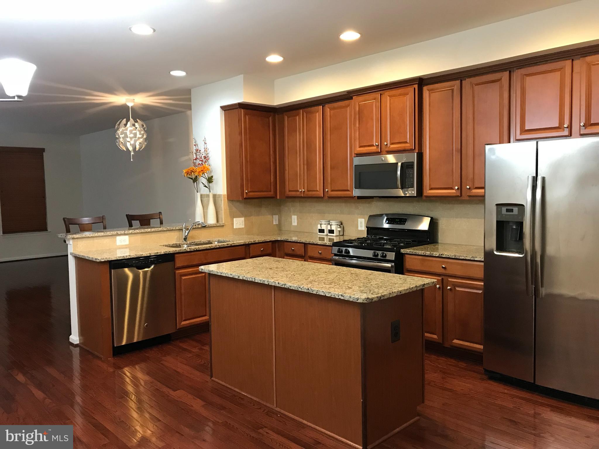 AMAZING RENTAL FIND!!! Beautiful 3 level townhome condo with 2 bedrooms, and a newly added  room in the basement that can be used for office/ den; and 2.5 bathrooms. Home boasts high ceilings, open floorplan. Rear entry large one car garage with fits a car and still has room for storage along with storage shelves that are installed in ceiling. Another vehicle can be parked in driveway, and plenty of open parking spots in front of the home. 
PROFESSIONALLY CLEANED, and MOVE IN READY!
Entry level has a room that can be used as an office, den, or bedroom, and half bathroom. Mid level boasts a large open dining room, living rom and kitchen that leads to deck. Modern townhome with many upgrades including high ceilings, hardwood floors throughout second level, granite countertops, upgraded cabinets, appliances, large sized washer and dryer. Great sized bathrooms with beautiful ceramic floors and countertop. A nice deck provides a beautiful relaxed view from the kitchen/family room level.
Community boasts a dog park, playgrounds, nature areas, ponds, tennis courts, clubhouses and more!