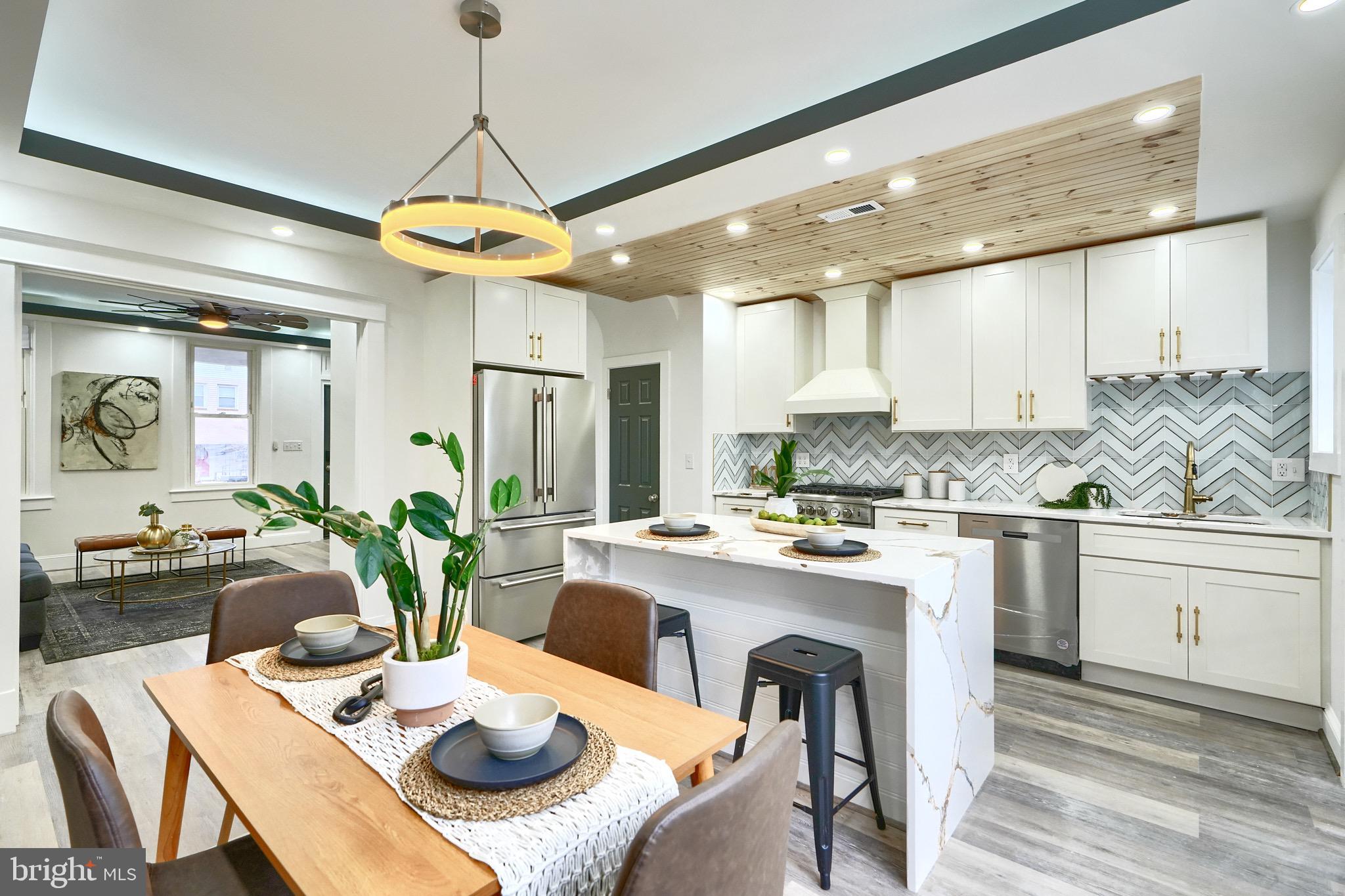 837 W 33rd Street has everything you can imagine in Hampden! Upstairs there are 3 bedrooms and 2 bathrooms, the main floor has a stunning kitchen with white cabinets, gold hardware, marble waterfall island, chevron backsplash, and a warm wood plank ceiling. The kitchen connects to the dining/living area that has large windows, tray ceilings, sleek lighting, and a powder room. Off the kitchen you will enjoy a private pergola with stylish wood detailing, perfect for relaxing or hosting gatherings and you will love the concrete driveway. The basement is finished with a powder room, laundry area and large rec room. Come check out this house today!