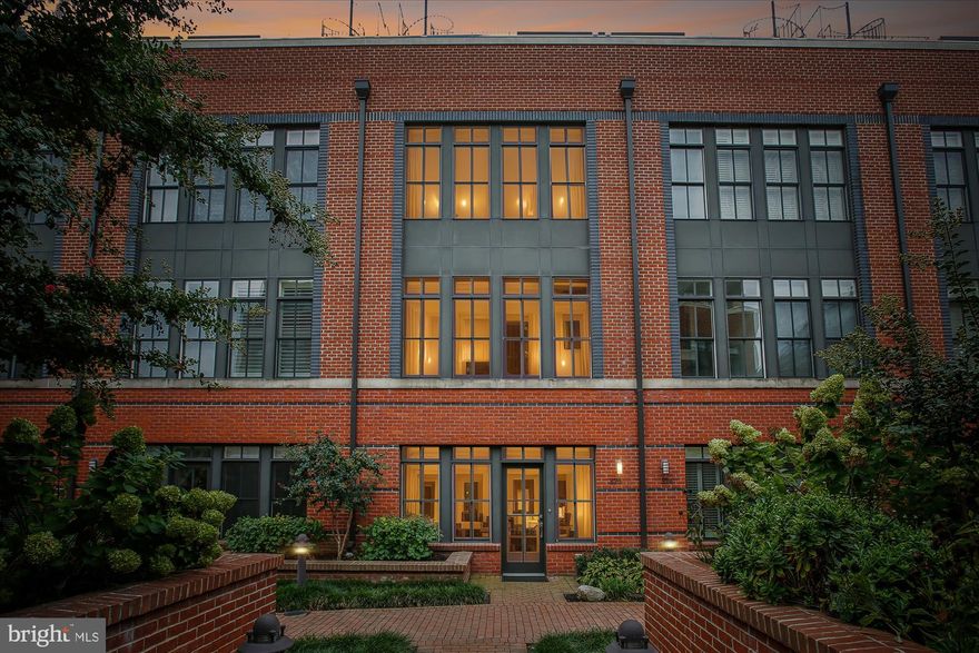 Tucked away in the highly sought-after and exclusive Printer’s Row community, this rare residence is one of only five fully gated homes, offering an unparalleled combination of privacy, security, and Old Town charm. The expansive main level welcomes you with a bright, open floor plan, soaring windows that flood the space with natural light, and seamless flow from the living and dining areas to a private rear patio—ideal for both everyday living and entertaining. The chef’s kitchen is a true centerpiece, featuring high-end appliances, ample cabinetry, and a thoughtful layout, while a convenient half bath completes the main level.

The private owner’s suite spans the entire second level and feels like a true retreat, boasting a spa-inspired bath with a soaking tub, oversized glass shower, double vanity, and generous closet space. A rear balcony extends the suite outdoors, providing the perfect spot to enjoy a morning coffee or evening unwind. On the third level, two spacious guest bedrooms with brand new LVP flooring share a full bath, and the conveniently located laundry room adds ease to daily living.

The upper-level loft offers versatility for a home office, media room, or gym and connects to a large terrace. From there, a dramatic spiral staircase leads to the crown jewel of the home—an expansive rooftop deck with  river views, ideal for gatherings, sunsets, and city lights. To top it off, this residence includes two reserved underground parking spaces, offering rare convenience and security in Old Town.

Ideally located in Old Town North, the home is just steps from the scenic Mount Vernon Trail and a short stroll to some of Alexandria’s best restaurants, cafes, and bars. With easy access to Washington National Airport, Metro, and downtown D.C., this home delivers the perfect blend of luxury, convenience, and Old Town lifestyle.