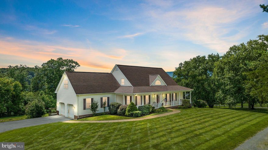 Home sweet home!  Riverfront property in the sought after Sandy Hook subdivision in Strasburg!  Over 4500 square feet of country living.  Outside of town limits but close enough to town for access to anything needed.  2 car garage! 5 bedrooms! Primary bedroom on the main level!  Corian countertops! Huge front porch!  Back deck!  Full unfinished basement to make your man cave, home theatre, or whatever suits your fancy!  Welcome home to this very spacious Cape Cod sitting on 4.11 acres.  Sitting on your front porch, you will see exceptional mountain views.  Walking through the front door and into the foyer, the main level features a separate dining room, living room with built-ins and French doors for entrance to the rear deck, primary bedroom and primary bathroom, another bedroom and full bathroom, kitchen with an island and Corian countertops, breakfast area, laundry room off the kitchen, thru the laundry room is access to the 2 car garage.  Inside the laundry room  on the main level is an entrance to another bedroom above the garage  with a nice walk-in closet. Walking up the stairs, you will find 2 more bedrooms, another full bathroom, and a huge storage area.  A full, huge, unfinished basement has a wood stove and walkout level to the back yard.  A path in the backyard takes you down to the flat, level area used for your entertainment by the river.  Roof is less than 5 years old.  This property has SO much to offer.  Call me today to check it out and make it yours!