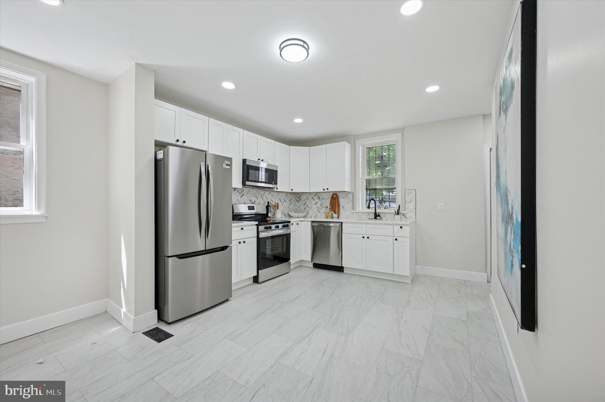 Welcome to 5013 Newhall Street, a beautifully renovated 6-bedroom, 2.5-bath home in the heart of Germantown. With over 2,500 square feet of living space across three spacious levels, this home offers the perfect blend of modern updates and timeless charm.
Step inside to find brand-new flooring, fresh paint, and a thoughtfully updated layout that flows naturally from room to room. The main level features a bright and open living and dining area, a sleek kitchen with stainless steel appliances, and a convenient half bath for guests.
Upstairs, you'll find generously sized bedrooms with ample closet space, along with two full bathrooms that have been fully updated with modern fixtures and tile work. Whether you're accommodating a large family or creating dedicated spaces for work and play, this home provides flexibility and room to grow.
Enjoy the outdoors with a rear deck and private yard, ideal for entertaining or relaxing. The in-law suite setup adds even more versatility, perfect for multi-generational living or potential rental income.
Located on a quiet residential block, you're just minutes from public transportation, La Salle University, local parks, and vibrant neighborhood shops and restaurants.
Move right in and enjoy the space, style, and comfort this turnkey home has to offer. Schedule your tour today.