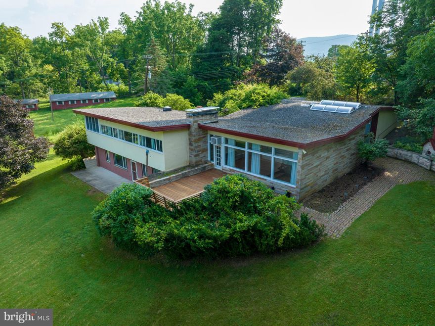 Incredible opportunity to create your own 3+ acre private oasis in this unique 4500+ sf. home located about a mile from campus and downtown and adjacent to Centre Hills Country Club golf course and one of the premier neighborhoods in State College. Some of the home's features include 4 bedrooms, 2 full and 2 half baths. A large solarium with 12' ceilings and a huge living room with 10' ceilings with a wall of windows facing the large deck and expansive back yard. Outside you will find an abundance of landscaping including a water feature, a built-in outdoor wood fired oven, and all the yard space you could desire surrounded by mature trees. The adjoining .41 acre fenced lot includes a barn and storage building and is included with the sale of this property for the list price.