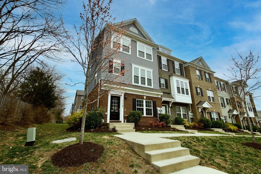 This turnkey brick front end unit townhouse has all the bells and whistles and all that's needed is you.  Let's start with the attached garage that can hold up to 2 vehicles with an additional 2 vehicles on the parking pad.  The main level has a sizeable foyer entry with loads of light from the trendy front door and the side windows.  There is a recreation room on this level, powder room and access to the garage.  The main level is an open floorplan and you'll be immediately wowed by the gourmet kitchen w/ a cooktop, double oven, built in microwave and extended island, a kitchen pantry and an additional half bath.  The living and dining rooms are oversized and can be used as needed.  Oh, let's not forget about the hardwood stairwells on both levels and LVP flooring on the main level.  You'll be amazed at how much sunlight floods the rooms and provides a tranquil setting. There is a deck for those summer nights and entertainment.  The upper level houses the laundry closet, 2 secondary bedrooms, a hall bath and the en suite primary bedroom with walk in closet and spa bath.    This property is conveniently located within a mile of a Metrorail station, a short commute to Washington, DC, The University of MD and University of MD Medical Center, Woodmore Town Center, Bladensburg, Joint Base Andrews, National Harbor, NSA, Annapolis, Baltimore and more.  There is shopping and convenience stores nearby and easy access to routes 50, 495, 202, and  295.  Put this one on your list and make an appointment today!