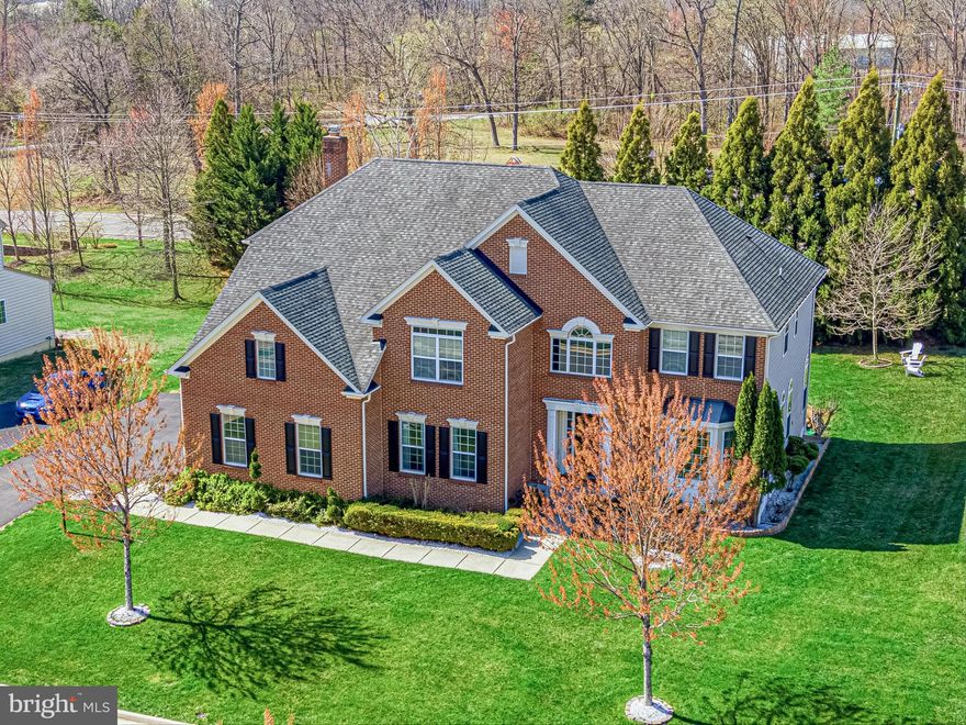 A timeless blend of elegance, warmth, and thoughtful design - this beautifully appointed home welcomes you with a sense of ease from the very first step inside.

A charming front walkway leads to the covered porch and into a grand two-story foyer, with front and back staircases connecting all three levels with ease. Sunlight fills the main level, highlighting hardwood floors, detailed moldings, and spaces designed for both everyday living and entertaining. A private study with French doors offers a quiet work-from-home retreat, while the formal living and dining rooms create an inviting setting for gatherings.

At the heart of the home, the gourmet kitchen features granite countertops, a center island with breakfast bar seating, and stainless steel appliances. The breakfast area opens to a slate patio with pergola, overlooking a tree-lined backyard - perfect for morning coffee or evenings outdoors. The kitchen flows seamlessly into the family room, anchored by a floor-to-ceiling stone, wood-burning fireplace and coffered ceiling. A mudroom drop zone, laundry and sorting room with utility sink, renovated powder room, and access to the three-car garage complete the main level.

Upstairs, the primary suite offers a true retreat with double-door entry, vaulted ceilings, a sitting area, walk-in closet, and a spa-like bath with dual vanities, soaking tub, and walk-in shower. Three additional bedrooms provide generous space, each with ample closets and en suite or Jack-and-Jill baths. A vaulted loft adds flexibility for a home office, reading area, or play space.

The fully finished lower level expands the home’s living space with a walk-out (stairs) recreation room, wet bar with seating, theatre room with projector and screen, a versatile bonus room for guests, gym, or hobbies, and a full bath. Engineered hardwood flooring, recessed lighting, and direct backyard access make this level ideal for both relaxing and entertaining.

Outside, the tree-lined yard and landscaping create a peaceful setting with space to gather or play. Ideally located, the home offers a sense of countryside living with convenient access to Dulles International Airport, Route 50, and Route 15. Nearby Brambleton Town Center and the Village at Leesburg offer shopping, dining, and entertainment, while Hal and Berni Hanson Regional Park provides trails, fields, and open green space. Wineries, breweries, farmers markets, and the charm of Middleburg and downtown Leesburg are all just minutes away.

Recent updates include hardwood flooring added to the family room and a renovated powder room (Spring 2025), new microwave and dishwasher (Fall 2025), pergola installation (Summer 2024), additional landscaping with river rocks and plantings (2023), and kitchen backsplash update (Summer 2022). The lower level was finished in Spring 2015, along with chandeliers and custom drapes. HVAC condensers, furnaces, and heat pump have all been replaced within the last six years, and the roof was replaced in 2010.

A home that offers space to gather, room to grow, and a setting to truly enjoy - this is where everyday living feels elevated, and where you won’t want to miss your chance to call it home!