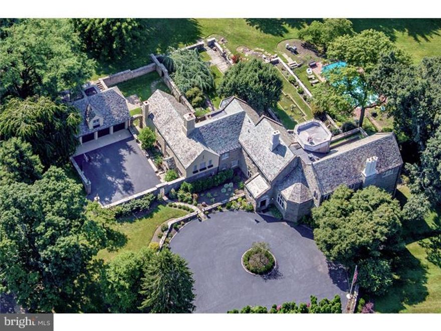 This magnificent estate home of stone with a slate roof perfectly combines Main Line architectural grandeur with luxurious state-of-the art amenities.  Old world elegance includes hand carved millwork, limestone accents and massive leaded glass stained windows.  The beauty is not just in the details, but on display in every room and out of every window. Majestically sited on 2.4 acres, the estate grounds will wow you with its handsome stone walls, gardens, walled motor court, swimming pool, reflecting pond and Terraces built to function as outdoor living rooms.  Inside, highlights include a Reception Hall, grandly proportioned Living Room with 20 foot beamed ceiling & fireplace with Scotch fireplace, a Gourmet Kitchen with adjacent Dining Area and reconfigured Family Room/Recreation wing.  The 2nd floor includes an expansive Master Retreat with vaulted ceiling, Sitting/Dressing Room, private Bath & Study/Office/Exercise Room, plus 5 additional Bedrooms, 4 Baths & Laundry Room. A separate 4 car Garage features a 2nd floor apartment with Kitchenette, Bedroom & Bath.  There are simply too many significant upgrades and exquisite appointments to mention.  Also listed with one additional acre, 3.5 acres for $2,149,000.