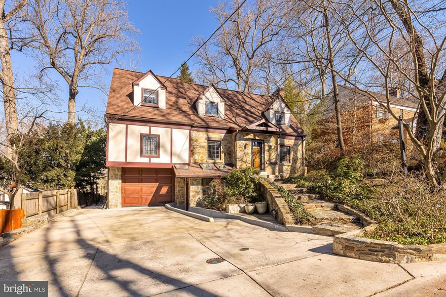 TODAY'S OPEN HOUSE IS CANCELLED.
Introducing an exquisite 6-bedroom, 4.5-bathroom residence nestled in Woodhaven. Boasting an expansive 5,000+ square feet of living space, this home exudes elegance and comfort. The charm of the original tudor home meets the addition full of modern amenities, including an elevator servicing all three levels. Step into the inviting living area, complete with a charming stone fireplace, ideal for cozy gatherings. Next is a separate dining room, then the well-appointed kitchen is a chef's delight featuring modern appliances and abundant storage. The kitchen opens to a bright and airy family room with skylights and a wall of windows bringing the outside in. Enjoy the deck off of the family room that looks out on the lush private backyard. Finishing off the main floor is a large office with built-ins and a powder room.

Upstairs, the primary bedroom is a luxurious retreat with a spa-like en-suite bathroom and generous closet space. There are an additional four bedrooms (one large enough to be used as a game room or upstairs family room), additionally there is an office, and two more full baths. The fully finished basement offers versatile space for recreation and relaxation, or options for a home office. Additionally in the lower level is a bedroom and full bath. From the lower level, walk out to the tree lined private backyard.

There is an abundance of storage space and a garage with a hydraulic lift.  The home has an energy-efficient multi-zoned geo-thermal heat pump/cooling system, a tankless hot water heater, 38KW Kohler whole house generator, a 50-year warranty on roof (parts and labor, transferable), gutters, and gutter guards 
(Long Roofing) – installed 2020.

  Conveniently located close to the shops and restaurants of downtown Bethesda, this home also offers proximity to major routes to VA & DC. Boasting a prime location within the Walt Whitman High School boundaries this home epitomizes the perfect fusion of luxury, comfort, and convenience.