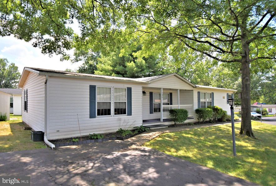 Move right into this 3 bedroom 2 full bath home with some updated features on this large corner lot. Stroll in from a covered front porch to a very spacious living room with vaulted ceiling, new luxury vinyl tile flooring (2024), and newer permanently installed electric fireplace with mantel (2021). The generous sized kitchen offers plenty of counter and cabinet space along with a newer Butler's Pantry. Just off the kitchen is a dining area with chair rail and new luxury tile flooring (2024). The primary bedroom is spacious in size and boasts a walk-in closet and ceiling fan. The primary  bathroom boasts a newer  easy to get in & out Bath-Fitter walk-in shower.  The other two nice-sized bedrooms offer plenty of space for over night guests. All three bedrooms have a walk-in closet and ceiling fan. The full hall bathroom offers a shower/tub combo. There is also a laundry/mud room with cabinets located right off the kitchen. Outside boasts a large cement patio for cookouts, a newer roof (2020),  and a storage shed for all your outdoor tools. This community offers a clubhouse if you like to read, play card/board games, or exercise. There is also an outside in ground pool to stay cool from the summer heat and a walking path to stay fit. Just minutes from major highways, shops, and restaurants!