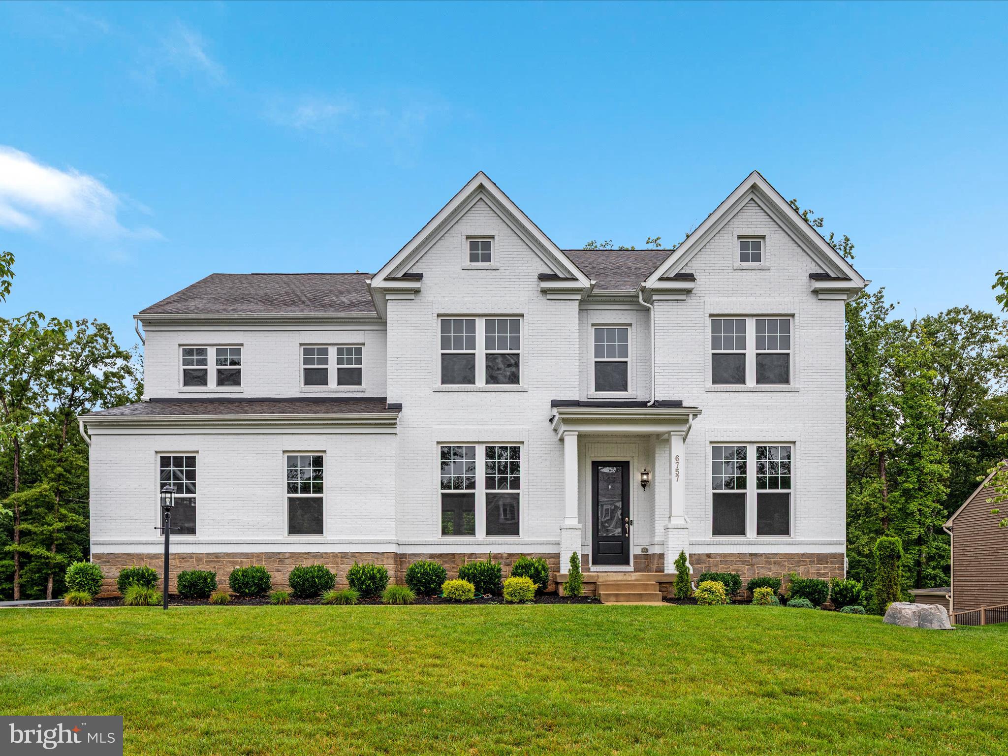 No detail was overlooked in this 5-year young Stanley Martin Kasey model nestled on a premium lot backing to trees in sought after Potomac Reserve. A covered portico, wonderful roof lines, side load 2 car garage and oversized driveway welcomes you home. With close to 5,700 finished square feet, the open concept interior is an environment of refined authenticity and elegance with stylish and durable laminate floors; upgraded fixtures and finishes; triple crown moldings; plenty of recessed lighting; and a neutral color palette throughout ready for your personal touches. The gourmet kitchen is a chef's dream, boasting a massive island with ample seating and pendant lighting; walk-in pantry; quartz countertops; stainless steel appliances; and flows effortlessly to a generous eat-in area, a sun-filled morning room with wall-to-wall windows and a spacious living/entertaining room with coffered ceilings ready for game night or a quiet evening in next to the cozy fireplace. A main level office with glass French doors and formal dining or living room (whichever you prefer) complete the main level. Upstairs you’ll find 4 large bedrooms to include a suite with a private bath and a luxurious primary suite with a separate sitting area, a huge near 130 square feet walk-in closet plus an additional smaller walk-in closet, and a spa-like en suite bath with a glass frameless shower, separate jetted soaking tub, dual vanities and water closet. Upper-level laundry with utility sink for added convenience. The finished walk-out basement has a sprawling rec room with wet bar, awesome media room (w/ in-ceiling premium surround sound that coveys), full bathroom, 5th bedroom and plenty of storage. Dual Zone HVAC for added comfort and efficiency. Two water heaters! Spend countless evenings letting your stresses fade into the sunsets or grilling with friends and family on the peaceful composite deck overlooking mature trees. Great community in a desirable school district just minutes from groceries, restaurants, parks and major commuting routes. Welcome home!