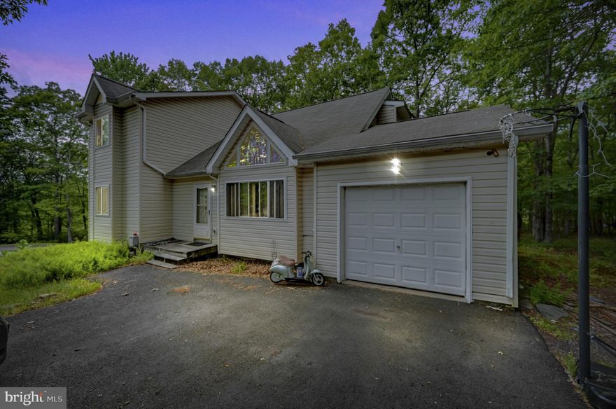 A great value opportunity to own your own home in Glen at Tamiment! Peaceful and Safe Gated Community this will make a great starter home for your young family! Roll up your sleeves, bring your hammer and paintbrush and make it your own! This contemporary is a 4 Bedroom 2 Full Bath with Garage on a partially cleared .43 Acre and Cul-De-Sac. Vaulted Ceilings and Laminate Flooring in the Living Room and Sitting room on the second floor. Open concept Dining/kitchen area with a deck off the back! AS-IS SALE and priced accordingly.