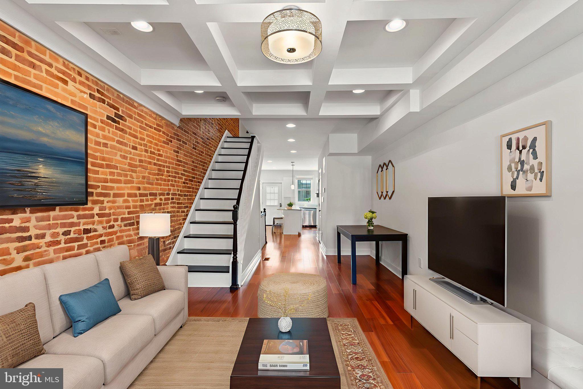 Welcome to 330 S Clinton Street, a stunning city home that combines historic charm with modern luxury. A few blocks from Patterson Park and minutes to Canton and Fells Point, this spacious 3-bedroom, 4-bath residence features over 1,600 square feet of beautifully finished living space across three levels. Inside, you’ll find gleaming hardwood floors, coffered ceilings, and exposed brick throughout. The open-concept main level boasts a sunlit living room, a dedicated dining area, and a gourmet eat-in kitchen with granite countertops, stainless steel appliances, 42" white shaker style cabinets, pendant lighting, and an oversized island with a breakfast bar — perfect for everyday living and entertaining. Each of the three generously sized bedrooms has its own private full bathroom — ideal for guests, roommates, or working from home. The finished walk-out lower level offers flexible space for a 3rd bedroom, office, gym, or den, along with laundry and extra storage. Enjoy panoramic city views from the private rooftop deck, your personal oasis for relaxing, entertaining, or watching fireworks. A rear parking pad provides convenient off-street parking. Highlights include: 3 Bedrooms, A Powder Room and 3 Full Baths (Separate, Non-Walkthrough Bedrooms), Rooftop Deck with Sweeping Views, Hardwood Floors & Exposed Brick, Recessed Lighting on All 3 Levels, Stainless Steel Appliances & Granite Counters, Walk-Out Finished Basement, Rear Parking Pad, Proximity to Patterson Park, Shopping, Dining & Public Transit. This home delivers the very best of Baltimore living — space, style, location, and lifestyle. Don’t miss your chance to own this city gem. Schedule your tour today!