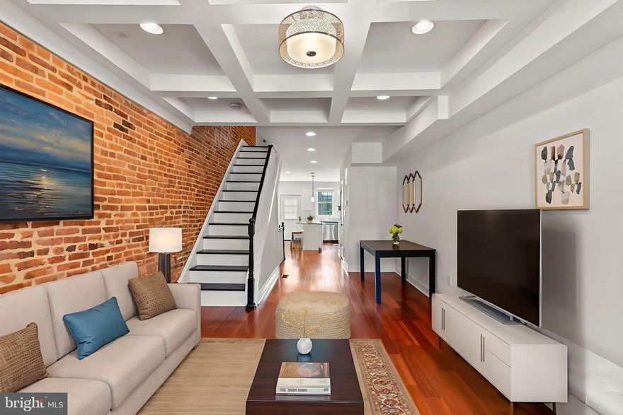 Welcome to 330 S Clinton Street, a stunning city home that combines historic charm with modern luxury. A few blocks from Patterson Park and minutes to Canton and Fells Point, this spacious 3-bedroom, 4-bath residence features over 1,600 square feet of beautifully finished living space across three levels.  Inside, you’ll find gleaming hardwood floors, coffered ceilings, and exposed brick throughout. The open-concept main level boasts a sunlit living room, a dedicated dining area, and a gourmet eat-in kitchen with granite countertops, stainless steel appliances, 42" white shaker style cabinets, pendant lighting, and an oversized island with a breakfast bar — perfect for everyday living and entertaining.  Each of the three generously sized bedrooms has its own private full bathroom — ideal for guests, roommates, or working from home. The finished walk-out lower level offers flexible space for a 3rd bedroom, office, gym, or den, along with laundry and extra storage.  Enjoy panoramic city views from the private rooftop deck, your personal oasis for relaxing, entertaining, or watching fireworks. A rear parking pad provides convenient off-street parking.  Highlights include:  3 Bedrooms, A Powder Room and 3 Full Baths (Separate, Non-Walkthrough Bedrooms), Rooftop Deck with Sweeping Views, Hardwood Floors & Exposed Brick, Recessed Lighting on All 3 Levels, Stainless Steel Appliances & Granite Counters, Walk-Out Finished Basement, Rear Parking Pad, Proximity to Patterson Park, Shopping, Dining & Public Transit.   This home delivers the very best of Baltimore living — space, style, location, and lifestyle. Don’t miss your chance to own this city gem. Schedule your tour today!
