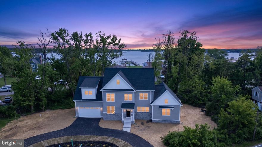 Beautiful new construction home located in the heart of the Poplar Ridge Peninsula.  Enjoy breathtaking water views from every angle.

The kitchen features beautiful quartz countertops, an island with seating, an abundance of cabinetry and counter space, and a spacious walk‑in pantry. Thoughtful upgrades throughout the home include a pot filler (convenience at its best!) and many additional extras.

This exceptional property offers dual primary bedrooms, each with a private ensuite bath—one on each level—both providing private outdoor access to relax and enjoy the peaceful sounds of the water.  The brick fireplace serves as a striking focal point in the main living area, perfect for cozy evenings.
The upper level boasts a spacious bonus room, and laundry access is available on both floors for added convenience. Take in the spectacular water views from the upper‑level balcony or the main‑level deck. 
A circular driveway adds ease and convenience for guest parking.   Even added a car charging outlet in the  oversized 2 car garage has 
This truly is a must‑see home, offering countless upgrades and special features you need to experience in person.