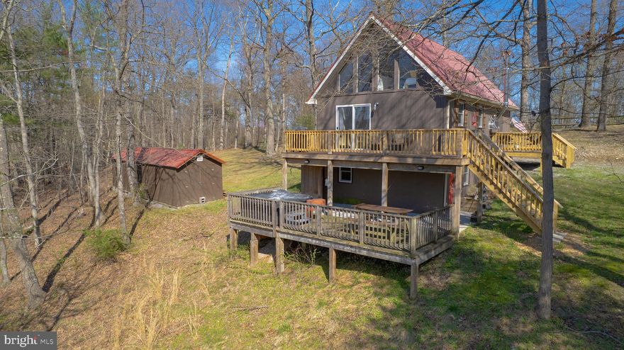 Rustic Cabin Retreat in Hedgesville, WV – Perfect for Getaways, Airbnb, or Full-Time Living

Escape the hustle and recharge in this super cozy, totally Instagrammable 2-bedroom + loft, 1-bath cabin nestled on 2.5 unrestricted acres in peaceful Hedgesville, WV. With 800 sq ft of charm and warm wood vibes, this spot is your go-to for weekend escapes, Airbnb dreams, or full-time slow living.

The layout is just right: vaulted ceilings, an open concept living space, a wood-burning stove for peak cabin vibes, a private upstairs primary bedroom, and a tucked-away guest room on the lower level. The loft? Perfect for WFH, yoga, reading nooks, or extra guests.

Outdoor perks? Oh yeah:

✨ Three decks to soak in the views (and your morning coffee)

🌌 Private hot tub for starry night soaks

🚿 Outdoor shower for that cabin-meets-beach feel

🔥 Firepit for s’mores, stories, and stargazing

Minutes to The Woods Resort for golf, spa days, and casual dining. Motorsports? Tomahawk MX Park is nearby. Nature + history? You're close to Cacapon Resort State Park, Harpers Ferry, Berkeley Springs, and Antietam.

You'll also find favorite farm markets, distilleries, breweries, bakery and coffee shops. It's all here. 

Just 90 minutes from D.C. and Baltimore, this property hits all the right notes—peaceful, practical, and Pinterest-worthy. Come see why life’s just better out here.