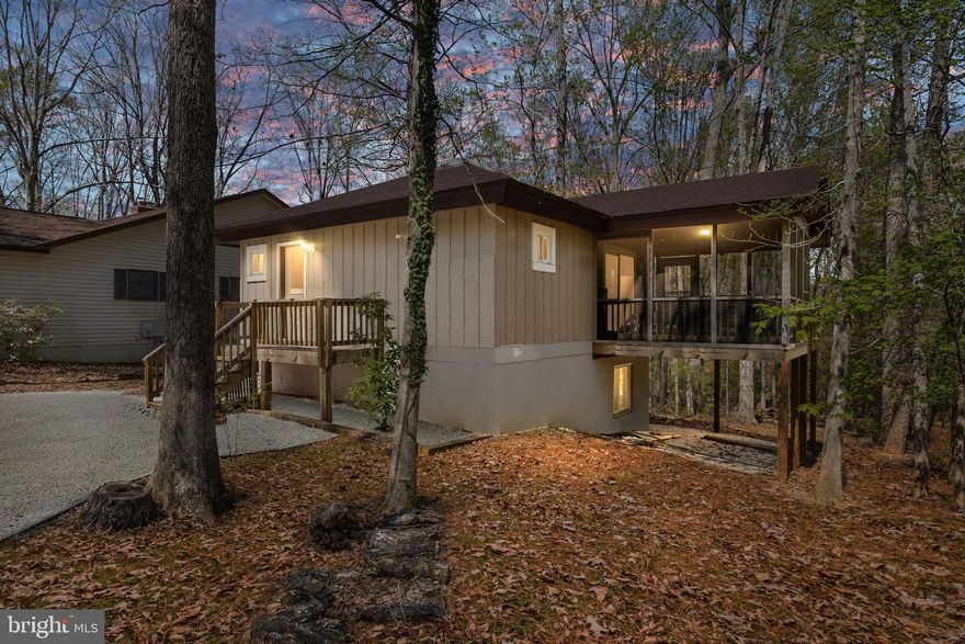 Lake of the Woods Gem! This remodeled home overlooks the golf course and offers privacy with updates throughout, including a renovated kitchen with stainless steel appliances, newer roof, updated windows, screened porch, and expansive 36’ deck. The open floor plan features high ceilings, a large skylight, and abundant natural light, creating a bright and inviting space. The lower level includes a newly updated bathroom with custom glass shower, ideal for guests or additional living. Located in Lake of the Woods, this gated community is the perfect blend of resort-style living and private retreat. Don't miss out!