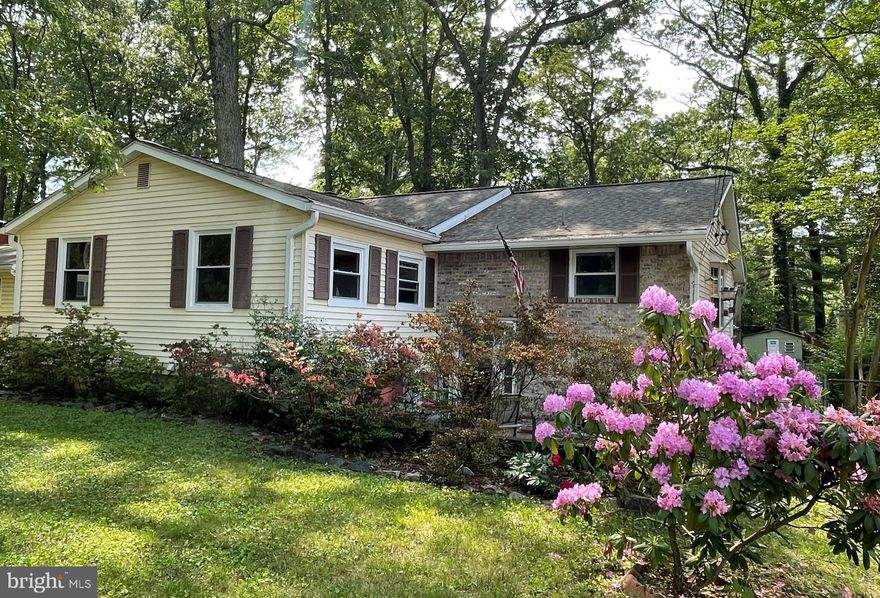 This is not your typical split foyer, this is a Great Home that is much larger than it appears from the street view. This home features 3 very large bedrooms on main level and the basement offers 2 more rooms that could easily be used for your 4th or 5th bedroom.  In addition, the lower level also offers a spacious family room with brick fireplace,  another large room that could have many possibilities but certainly offers lots of storage, a separate laundry room with yet more added storage  space.  The overall size and space of this home is incredible.   Large fenced in yard with mature trees offers a great atmosphere to relax, enjoy a cup of coffee or entertain on the deck. The roof, windows and HVAC system are newer and owners are offering a one year home warranty at settlement  This is your chance to live in an amenity rich community with multiple beaches. AS IS.