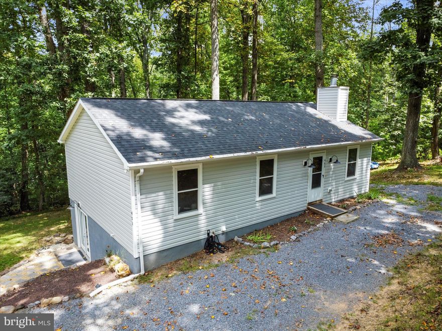 **PRICE IMPROVEMENT! Motivated sellers!** Updated rancher with finished basement on nearly a half acre lot with no HOA! Excellent location: the privacy of Shannondale without a long hike up a mountain, as this home is just 0.7 miles off Mission Road, on paved roads all the way.  If you've been wanting to have a big garden or raise chickens, you can! Lots of peace and privacy, with mature trees all around. Lots of recent improvements so you won't have to! New windows (2024), new well pressure tank (2024), new roof (2023), new HVAC (2024), new water heater (2022), new flooring and paint (2024), new flagstone walkway to basement entry (2024), freshly professionally cleaned carpets (2025). With all these upgrades, this home is move in ready! Enjoy Lake Shannondale, a private 55-acre lake with a beach and the Lakeside Bar & Grill. Close to hiking on Appalachian Trail and all the history in Harpers Ferry. This is the peace and privacy you've been looking for!