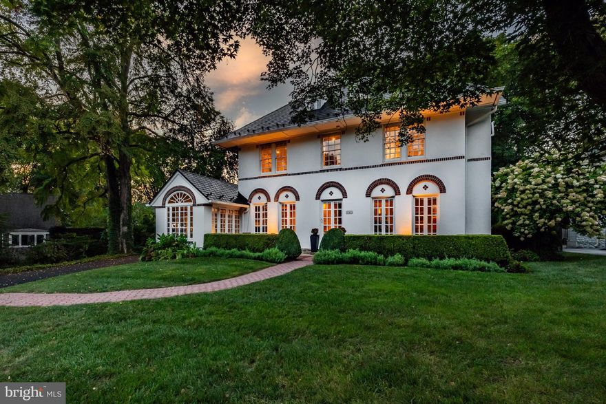 In a class of its own.  Welcome to 205 Roberts Rd, one of the most beautiful homes in Ardmore, with its unique Mediterranean Revival style, offering a location within a short walk to Suburban Square and so much more.  This stunning home features 5 bedrooms, 3.5 bathrooms and more charm than you’ll know what to do with!  Pull up and immediately fall in love with the beautiful design details of this early 1900's home, rich with architectural characteristics everywhere you turn.  The first floor has a wonderful flow to include a large and sunlit living room with 3 sets of French doors leading to the front porch, a classic fireplace, coffered ceiling and the original oak hardwoods in a beautiful honey tone.  Off the living room is the sunroom, a great space for lounging or entertaining guests with it's heated floor and beautiful windows.  The formal dining room has room for a larger table and server, also with French doors leading out front.  The eat-in kitchen has a butlers pantry area with original cabinetry and makes a great party set up or coffee bar, maple cabinets, granite counters, stainless steel appliances including top of the line fridge,  Wolf steamer, 2 tiered island with storage and a great breakfast nook with access to the back bluestone patio and private fully fenced backyard.  The half bath is perfectly tucked away under the stairs.  Use the front or back stairs to head on up! The primary suite is spectacular!  The bathroom was recently renovated to include Antracita Porcelain tile from Spain, a Bocchi Contempo fireclay farmhouse sink which is designed in Italy, a bidet, heated flooring and the most chic shower in town!   It’s truly one of a kind.  The primary bedroom has plenty of closet space tucked away behind custom slider doors that tie beautifully to the bathroom.  There are 2 more spacious and sunlit bedrooms on the second floor and another full bath.  Up on the 3rd floor are 2 more bedrooms and a 3rd full bath with a claw foot tub and a great view of the picturesque property.  The versatility of the floor plan is perfect for work at home, hosting guests or just the need for 5 bedrooms!  The walk-out basement is clean as a whistle and thoughtfully updated to include new flooring, new sink and cabinet, the installation of a full glass door to let the light in, tons of storage cabinets added and parging of the walls make this a great space for working out, doing laundry or just nice clean storage.  The property itself is perfectly private in the back, has a phenomenal 2 car detached garage with the original barn doors and a 2nd floor loft that can be converted into something magical.  Entertain your guests on the patio, surrounded by lush landscape and a natural privacy screen.   The current owners have poured love and resources into this home.  A perma lock metal roof with a lifetime warranty, updated electrical and many other thoughtful upgrades make this a phenomenal value.  This home gleams with old world detail, custom mouldings and is located in one of the best locations Ardmore, Lower Merion has to offer.   Walk to Suburban Square in minutes and enjoy upscale shops, cafes, a farmers' market with easy access to the train.  Enjoy live music at Ardmore Music Hall, a craft beer at Tired Hands or a movie at Bryn Mawr Film Institute.  This home offers a lifestyle and location that you’ll never want to miss.