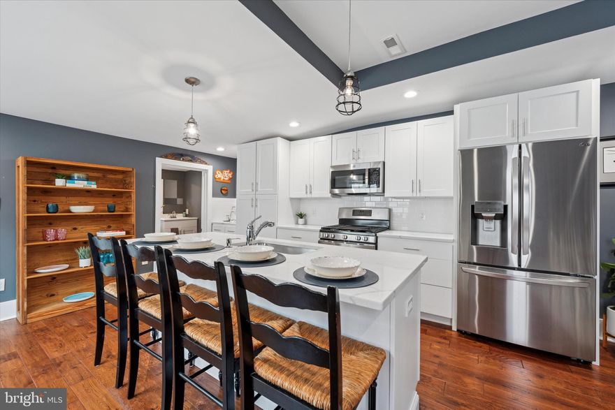Make Your Dream Home a Reality in Conshohocken! Welcome to this beautifully renovated 3-bedroom, 1.5-bath twin that blends modern comfort with stylish design, complete with the rare advantage of 2-car parking. Fully transformed from top to bottom during 2020-2021, this home showcases exquisite 3/4-inch hardwood floors and floods of natural light across the main level. Step into the warm and inviting living room, ideal for cozy nights in or casual gatherings with friends. The oversized kitchen is a true centerpiece, featuring 42" Wolf soft-close cabinetry, elegant granite countertops, classic white subway tile, and a Moen spray faucet over a stainless steel sink. A large kitchen island illuminated by pendant lighting provides the perfect spot for casual dining, meal preparation, or entertaining. The adjacent dining area enhances both charm and functionality, ensuring seamless flow from the kitchen. Conveniently located off the kitchen is a powder room with a cultured marble vanity, ideal for guests and daily use. Upstairs, two bright and spacious bedrooms await, each equipped with ceiling fans for comfort year-round. The beautifully updated hall bath features a glass-enclosed shower, subway tile walls, and a chic penny-tiled floor. The third floor offers additional versatile space, perfect for a guest room or home office. The full unfinished basement provides ample storage and is immaculately clean. Other updates include-updated electric, gas furnace, Central AC, new insulation, and newer appliances.Enjoy the vibrant lifestyle Conshohocken offers, with easy walkable access to shopping, dining, transit, and more—right at your doorstep.